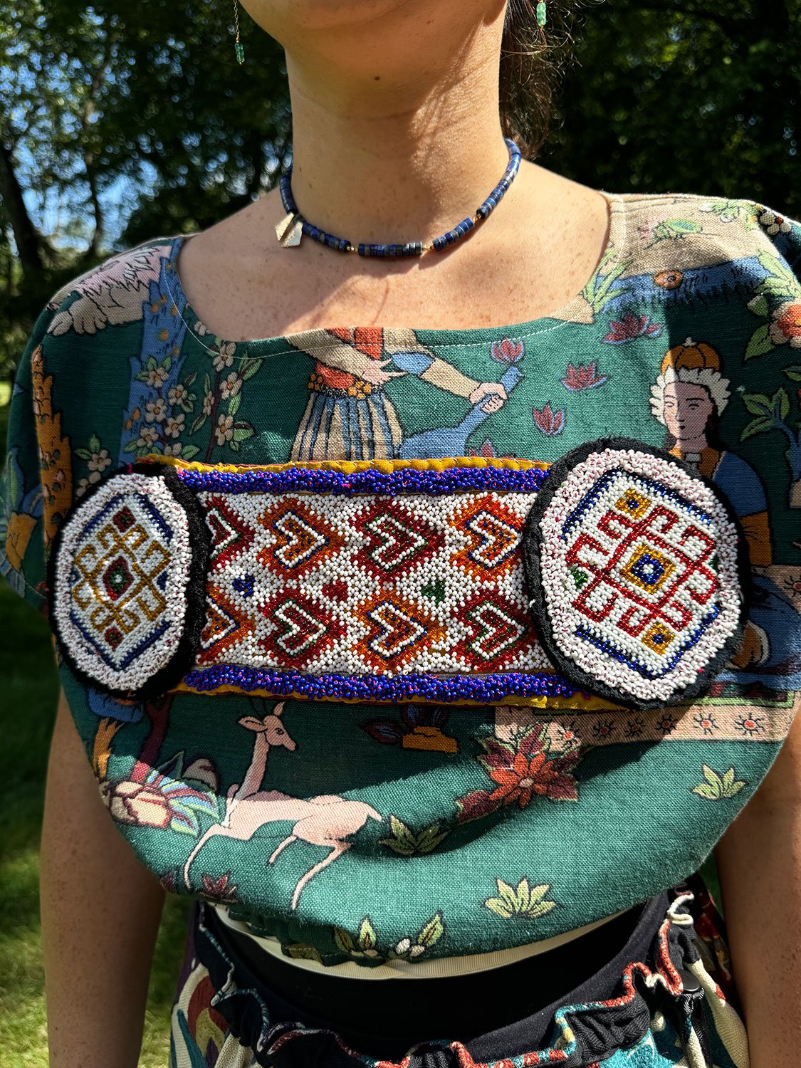 Frida Capelet with beaded antique tribal panel and Piper skirt/cape/dress on model close up details of fragment