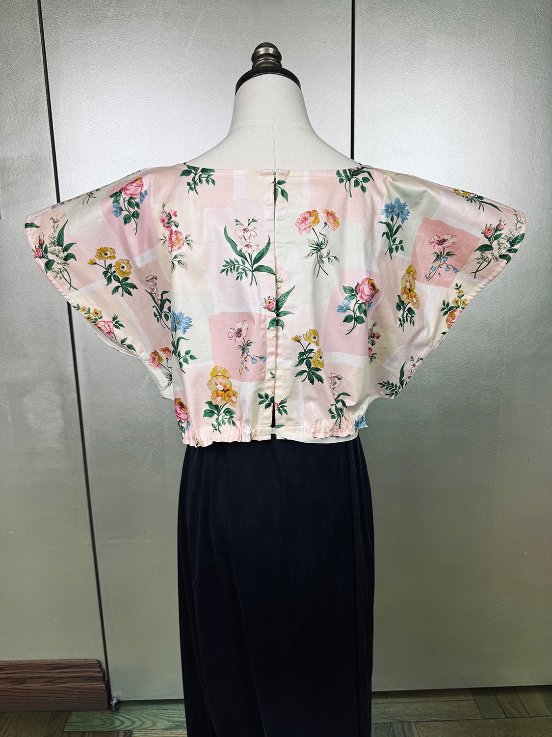 Frida Capelet pink coated chintz print on mannequin back view