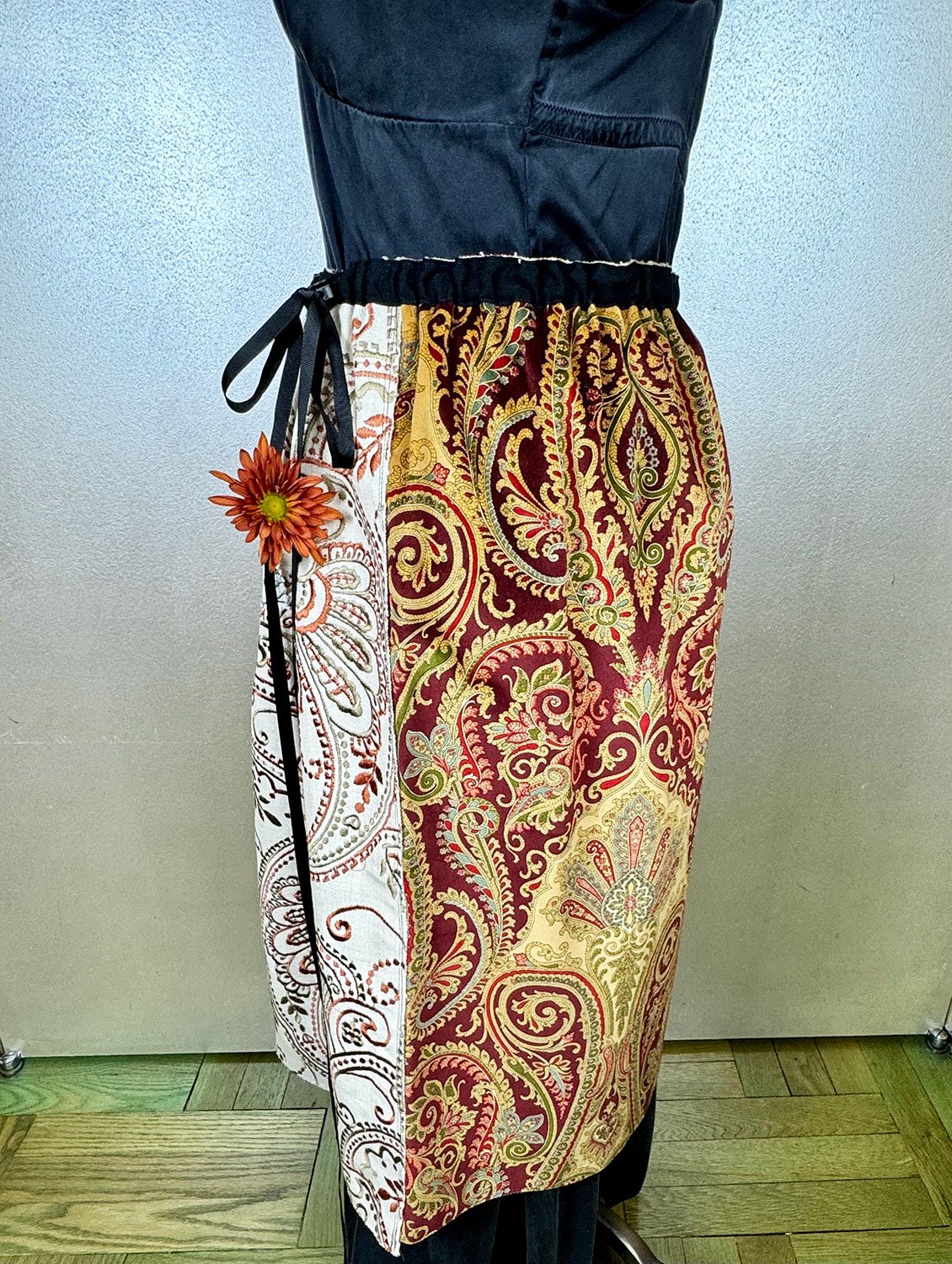Piper overskirt on mannequin hoodie pocket with flower close up worn with ribbon bow detail