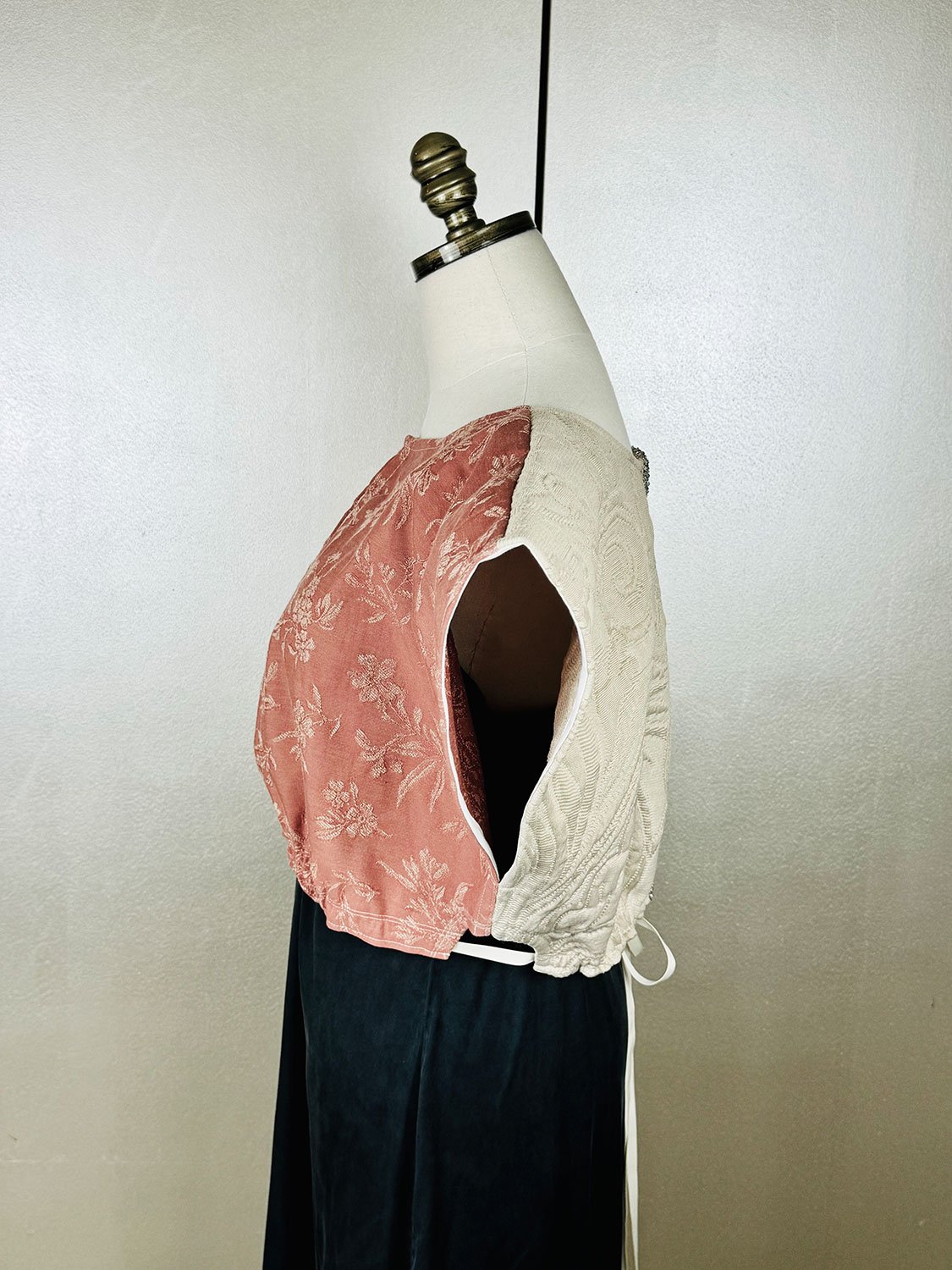 Frida Capelet on mannequin showing side view arm hole