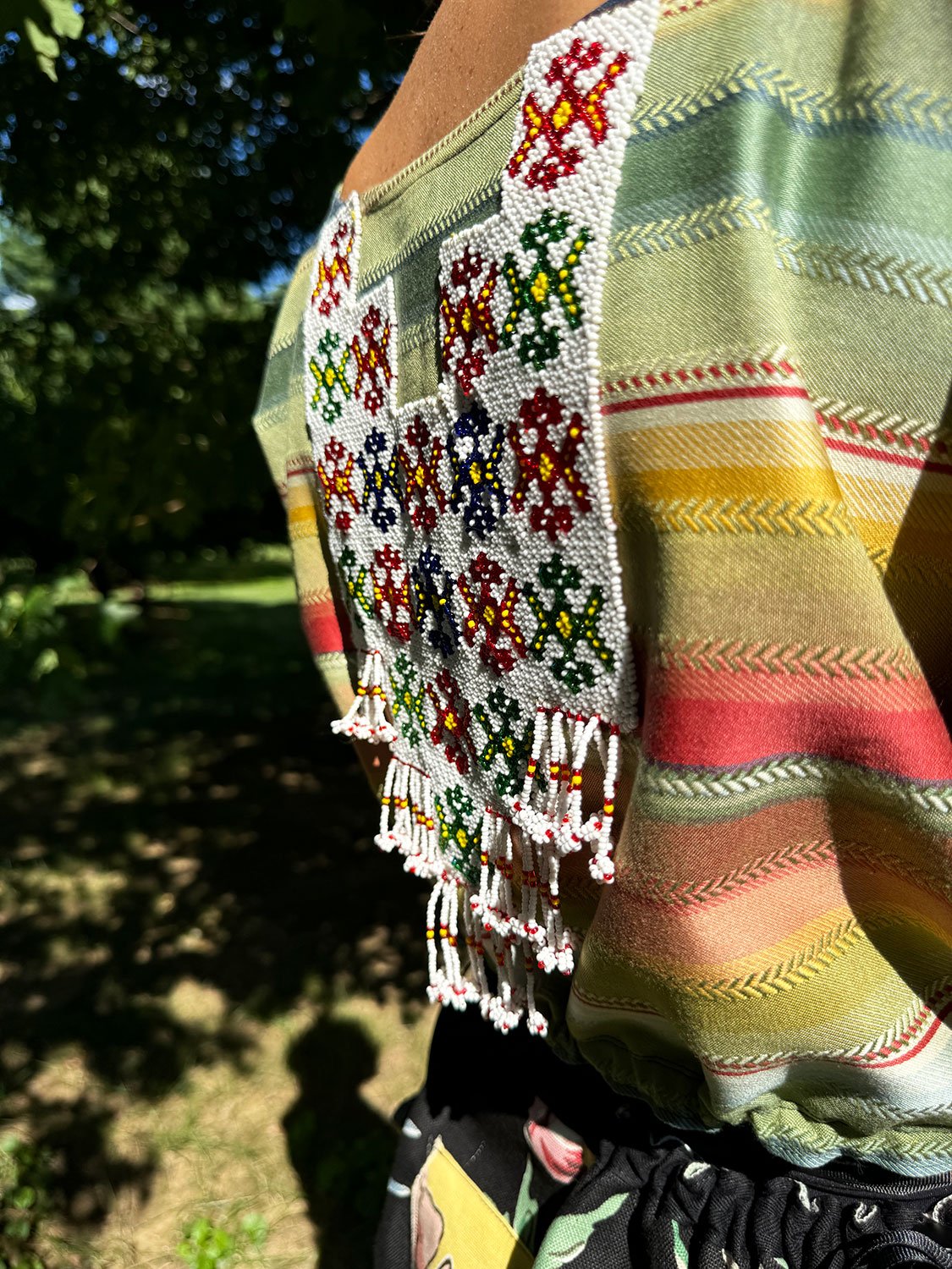 Frida Capelet with beaded antique tribal panel (close up side view) on model back