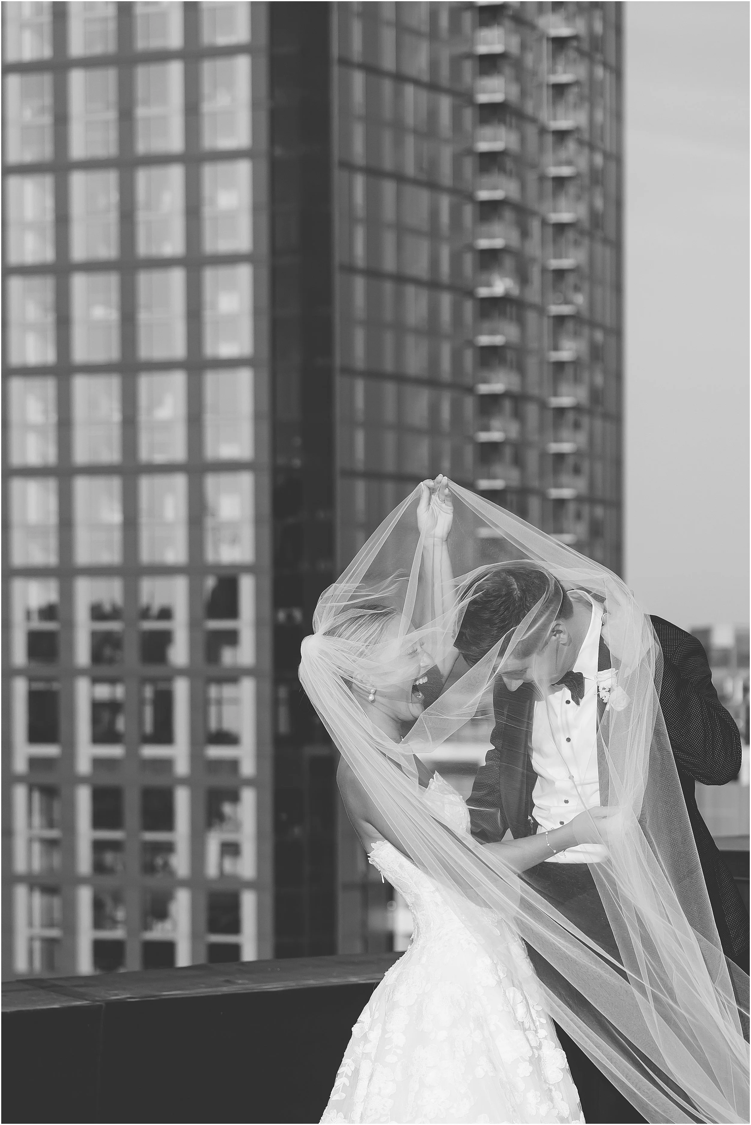 bride-groom-rooftop-downtown-under-veil-laughing.JPG