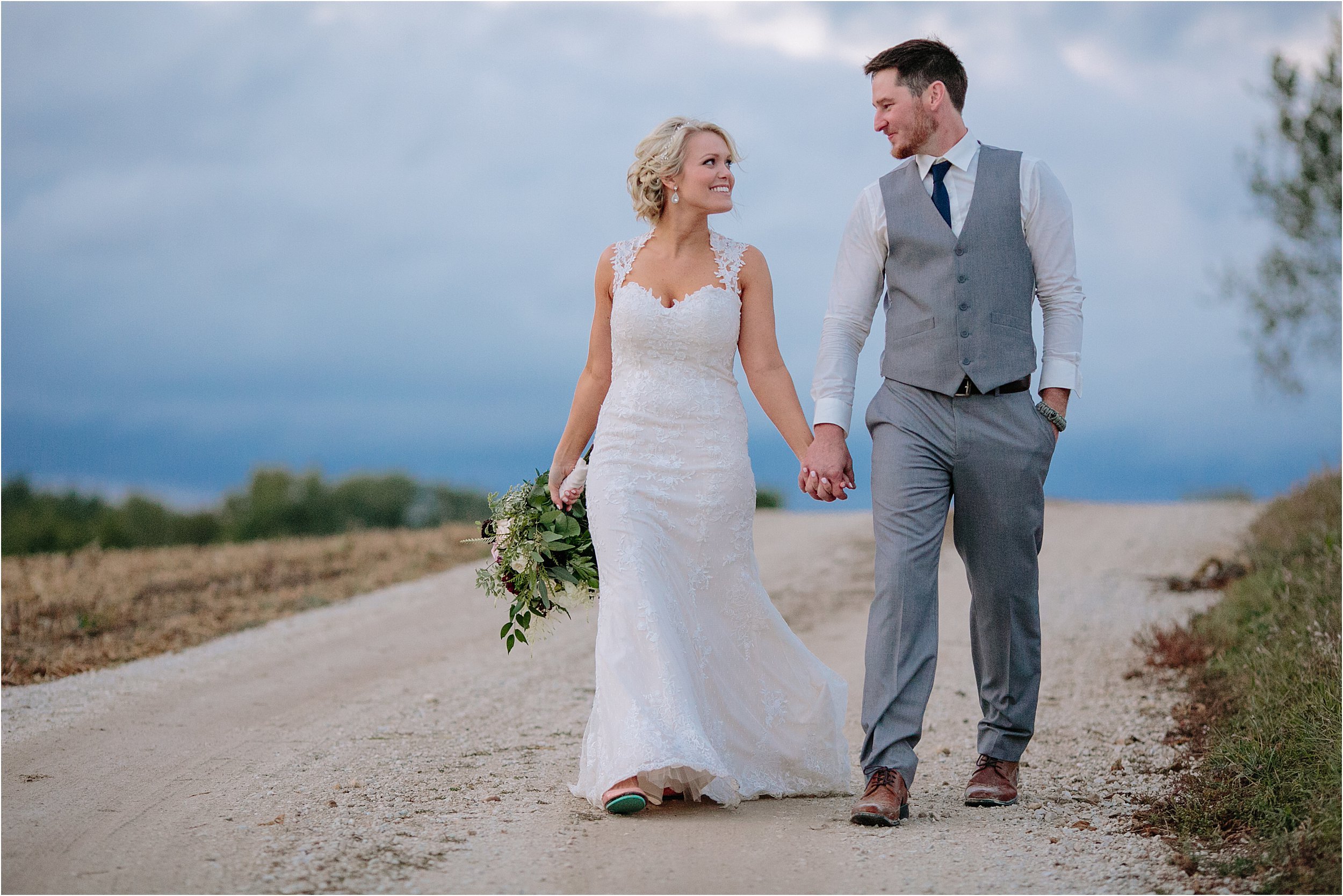 29-bride-groom-gravel-road-walking-hand-in-hand-blue-hour.JPG