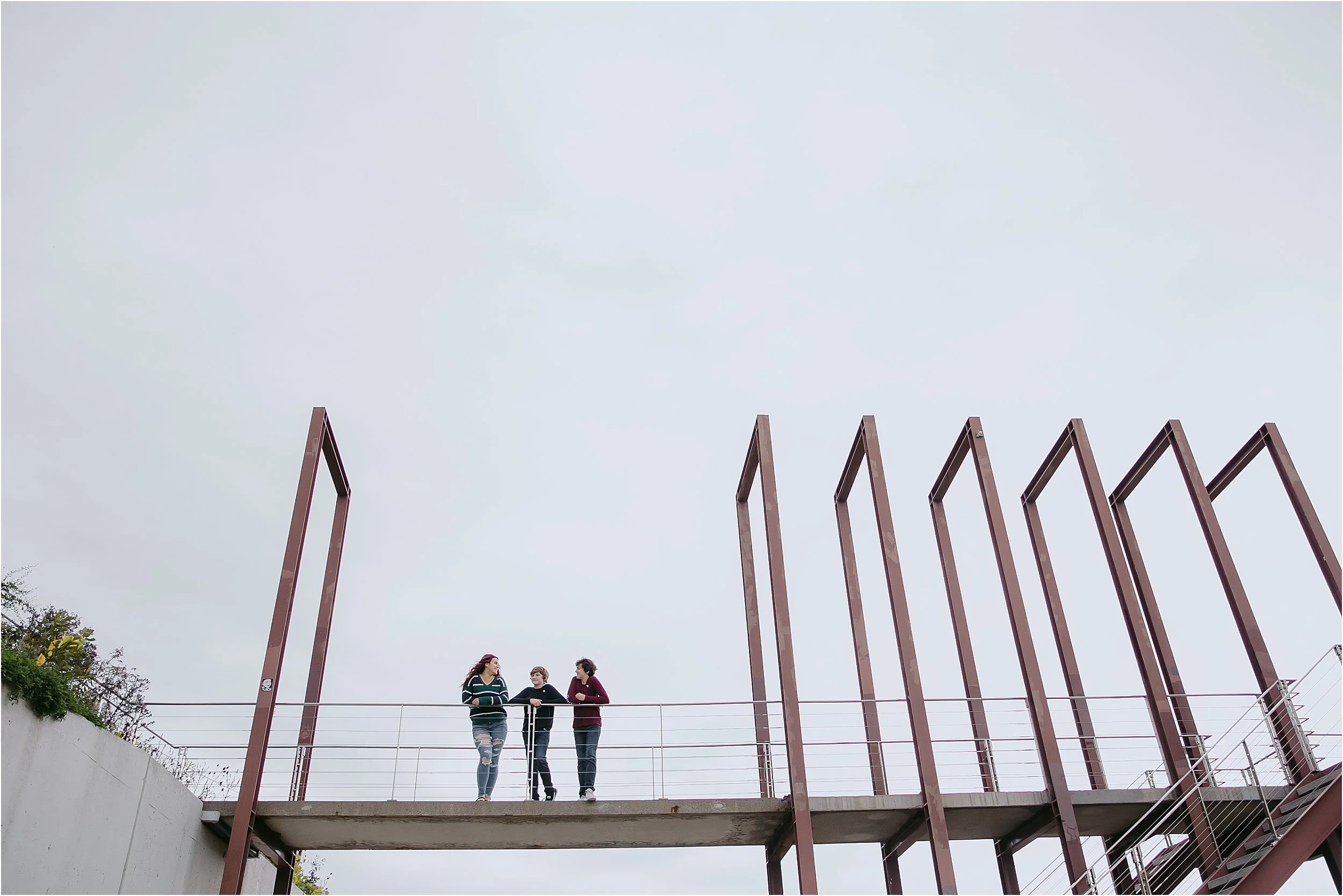 08-siblings-metal-walkway-overcast-sky.JPG
