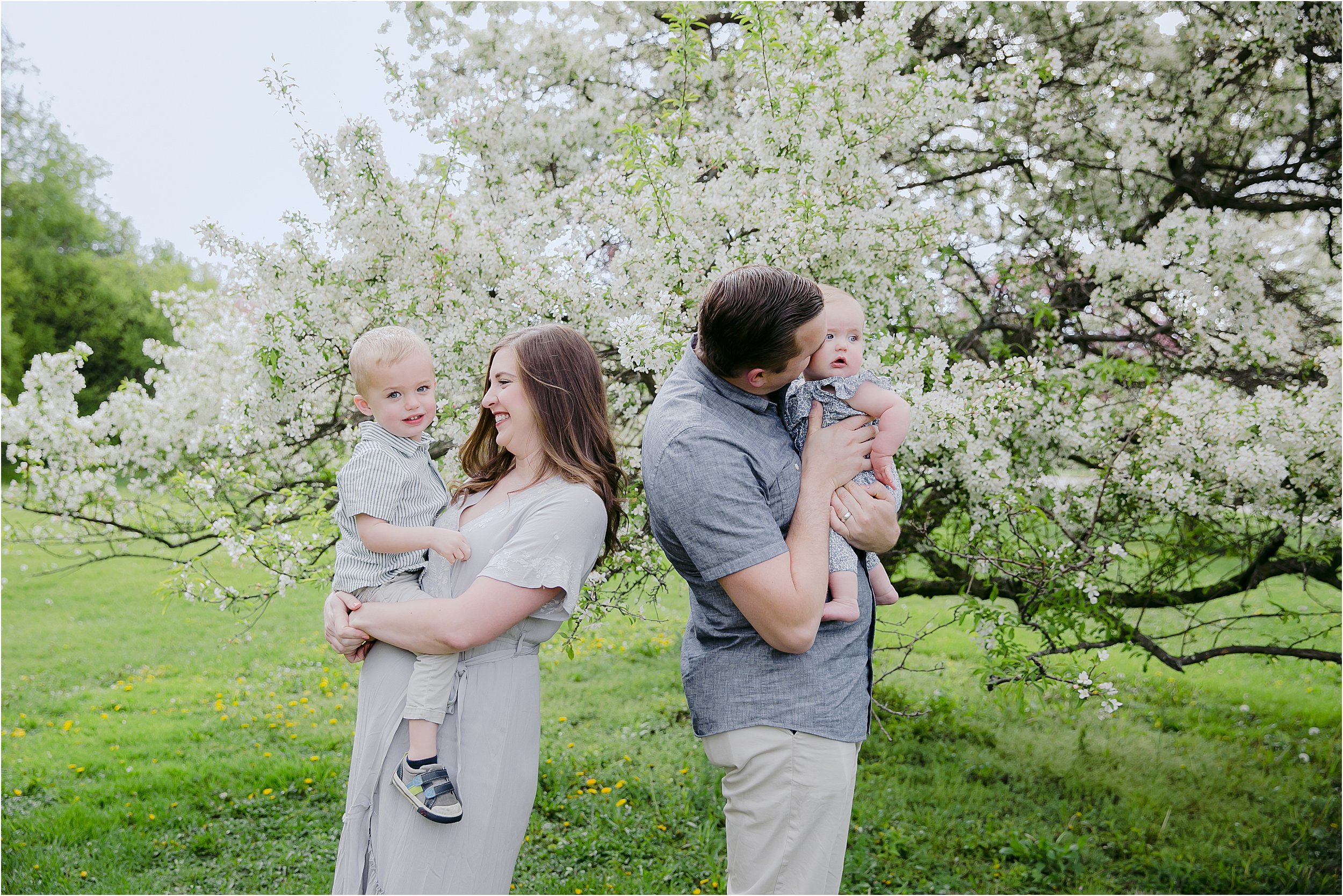 02-mom-dad-two-small-children-flowering-spring-trees.JPG