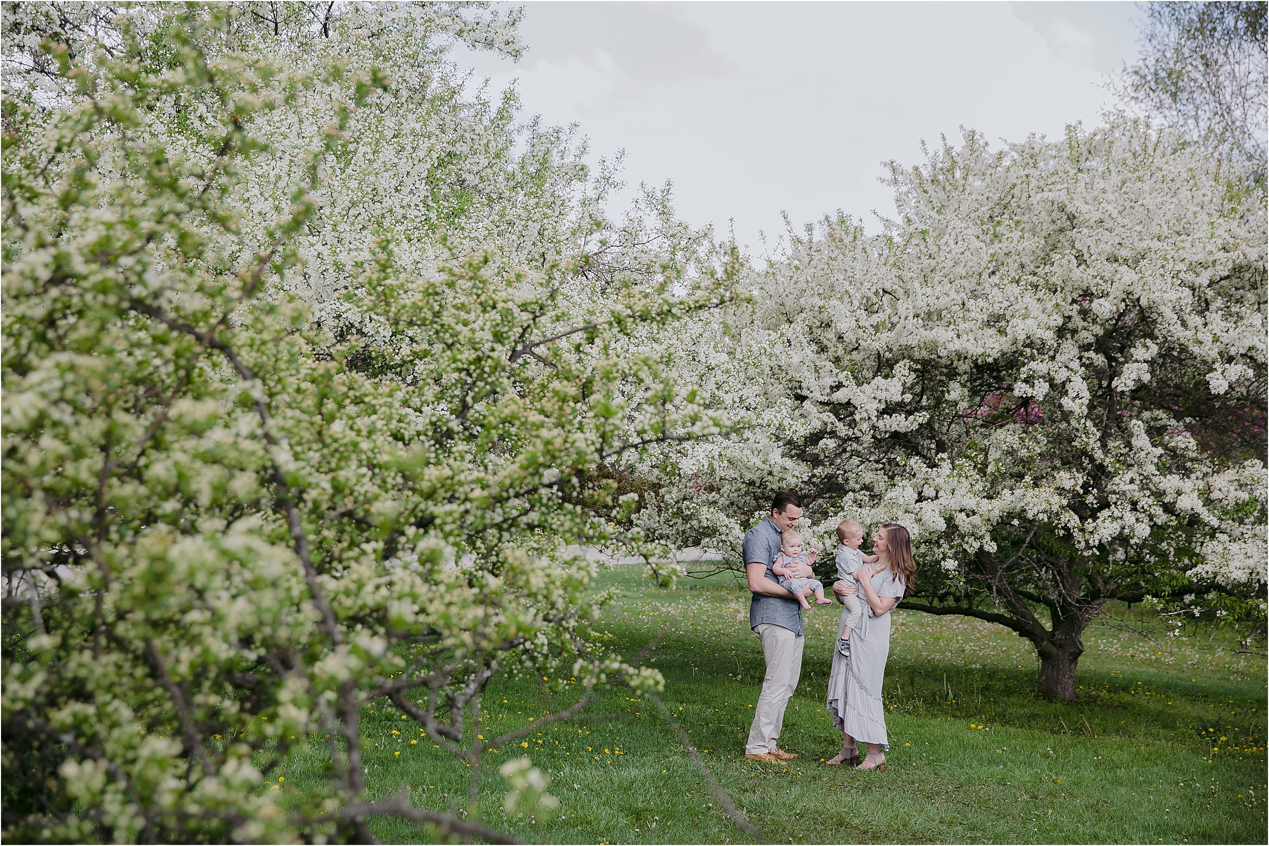 03-parents-holding-children-white-flowering-trees.JPG