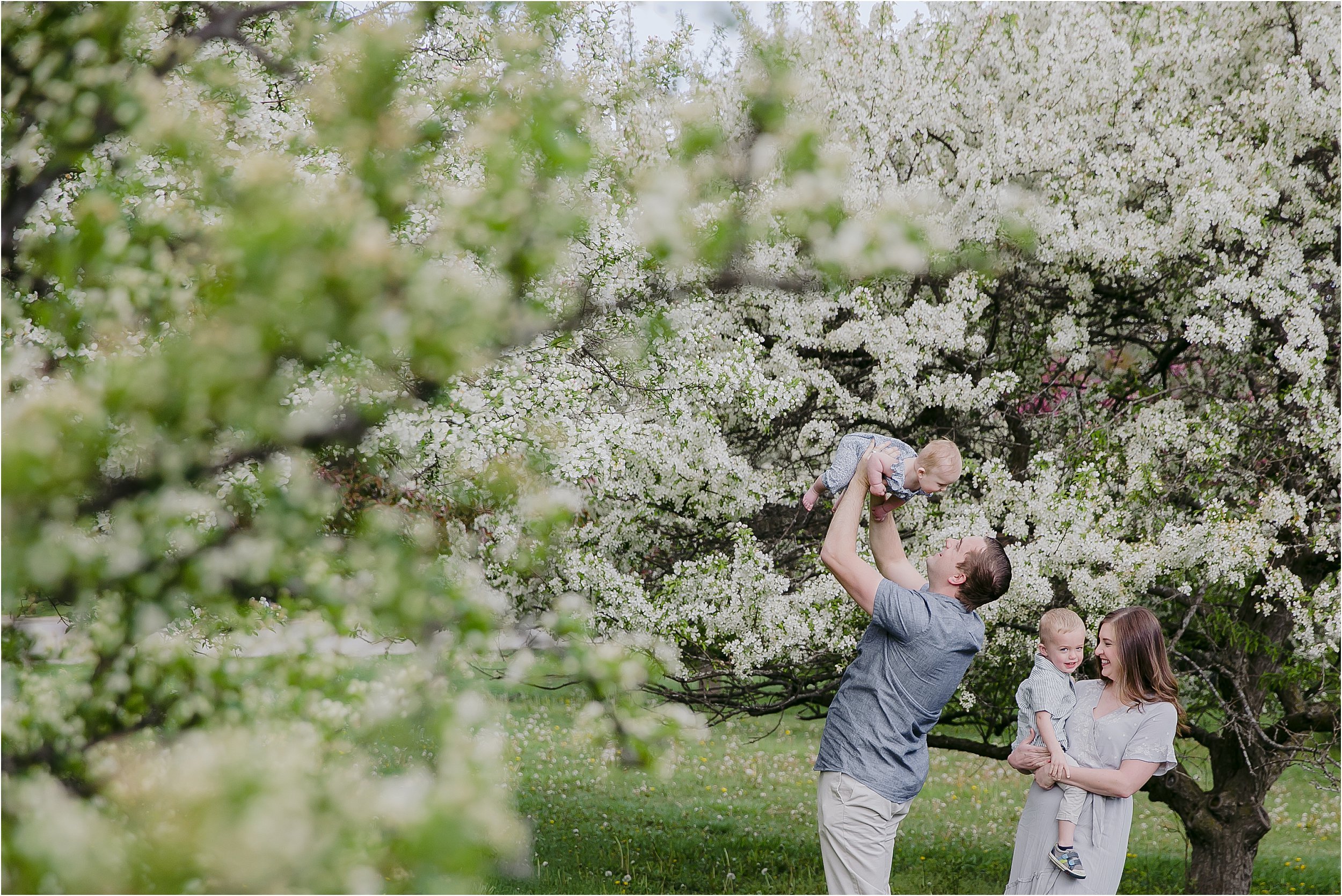 06-white-flowering-trees-parents-holding-children.JPG