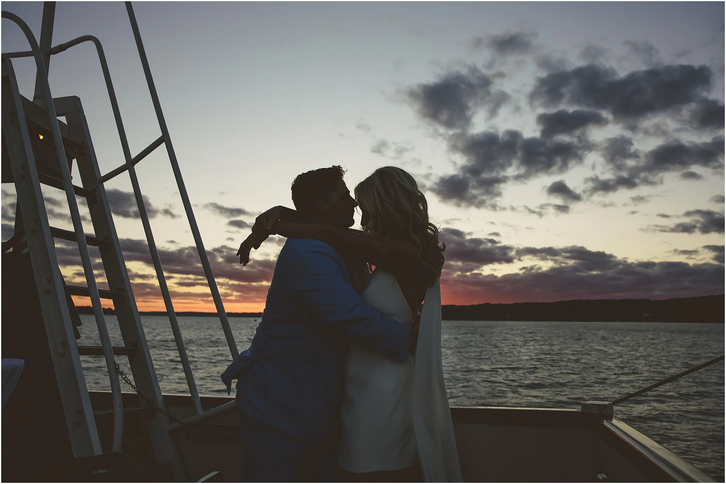 23-Lake-Geneva-boat-reheasal-sunset-cruise-bride-groom-blue-suit-white-dress-cape.JPG
