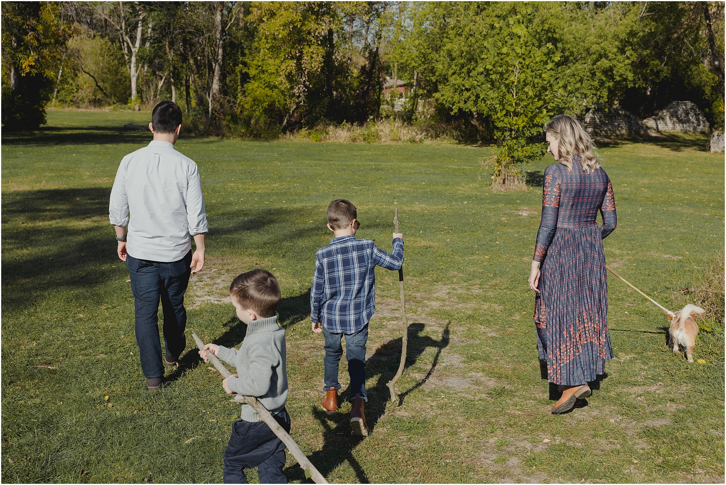 07-family-photo-session-with-dog-fall-leaves-blue-lake-gathering-sticks.JPG