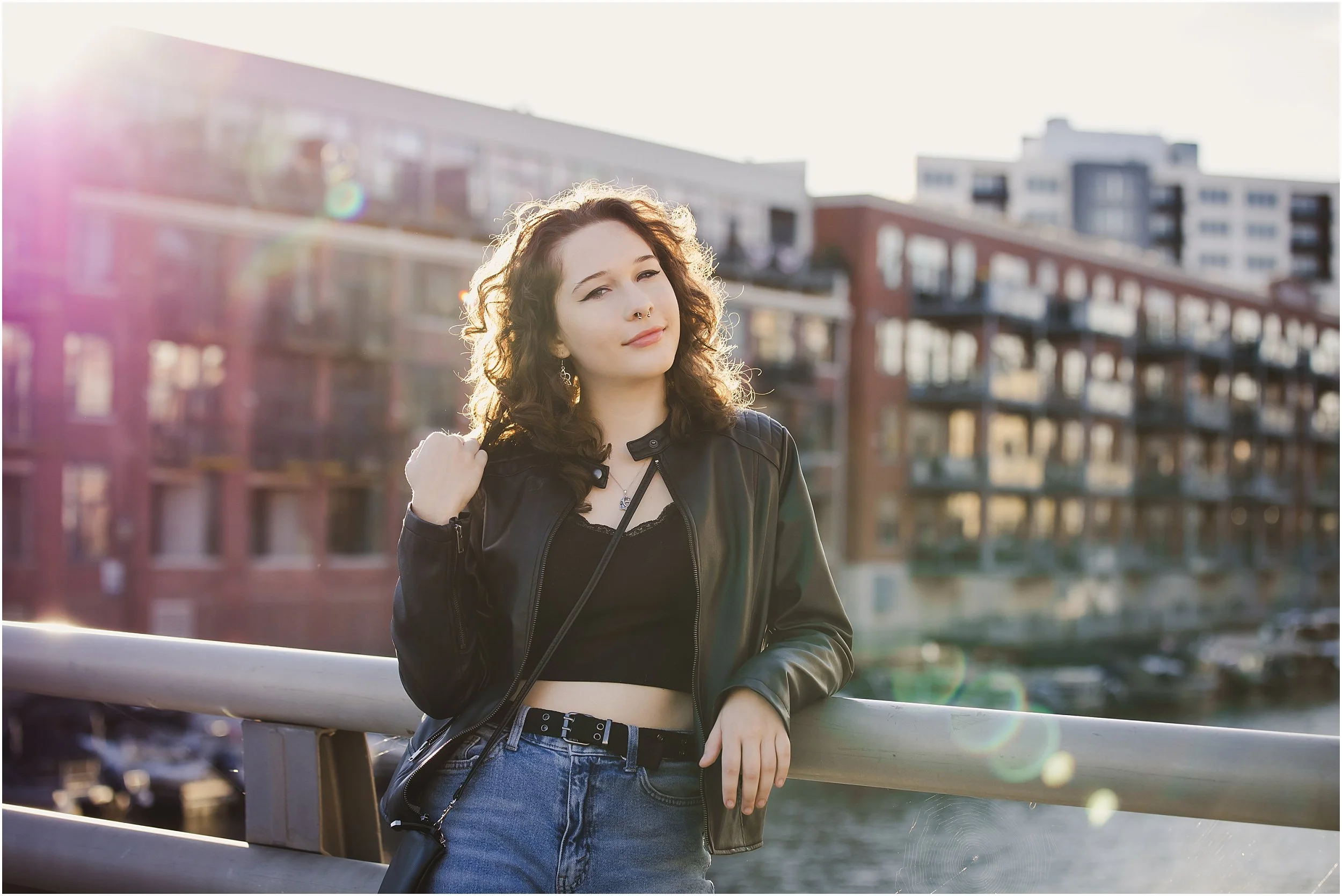 girl-leaning-bridge-downtown-artistic-sun-flare