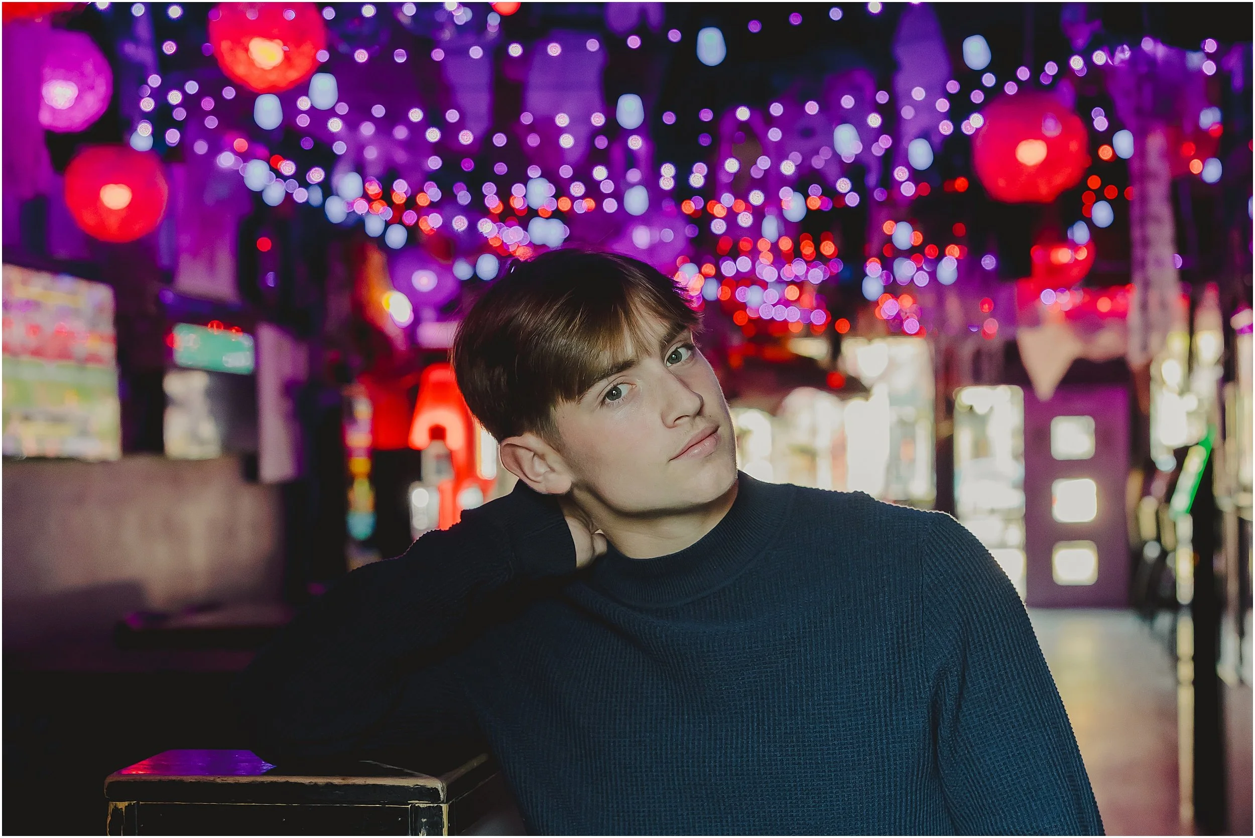 boy-leaning-red-purple-lights
