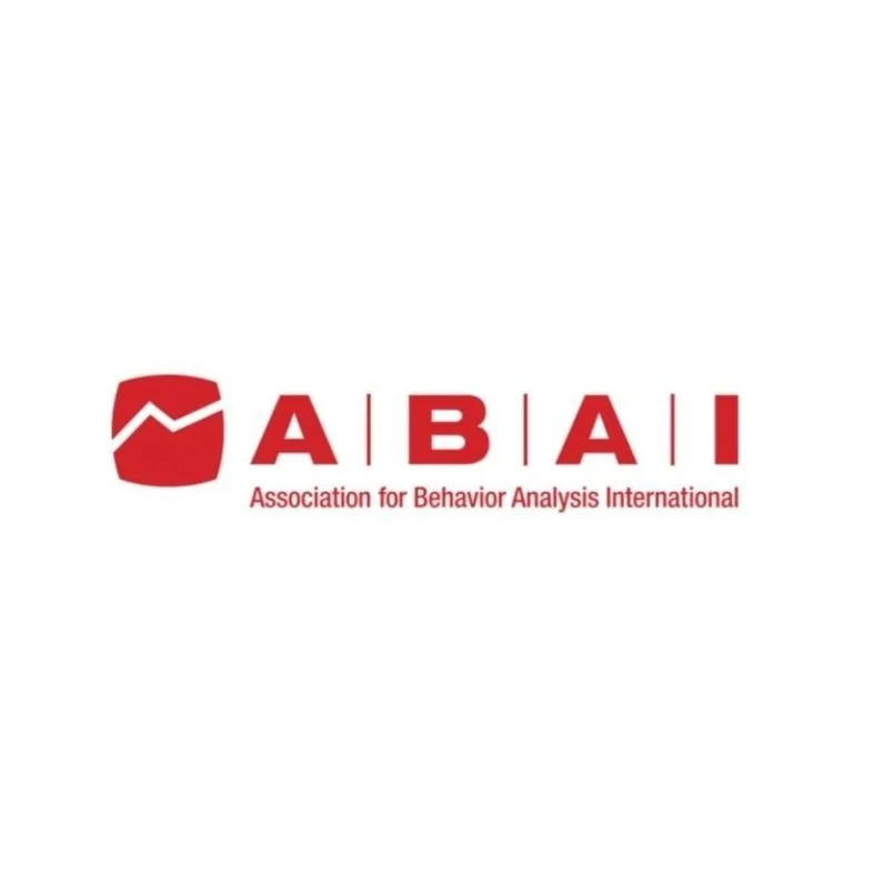 Logo of the Association for Behavior Analysis International (ABAI), featuring a red shield with a white line graph and the text 'ABAI' in bold red letters, along with the full name in smaller font below.