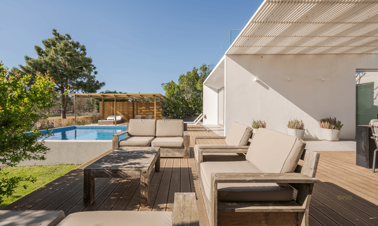 Modern resort-style swimming pool with dark interior finish and sun shelf, Australia 2026 design trends.