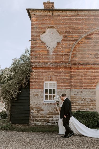 Butley_Priory_bride_groom_walking_suffolk_wedding_venue.jpg