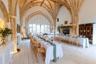 wedding tables with fairy lights at unusual wedding venue butley priory