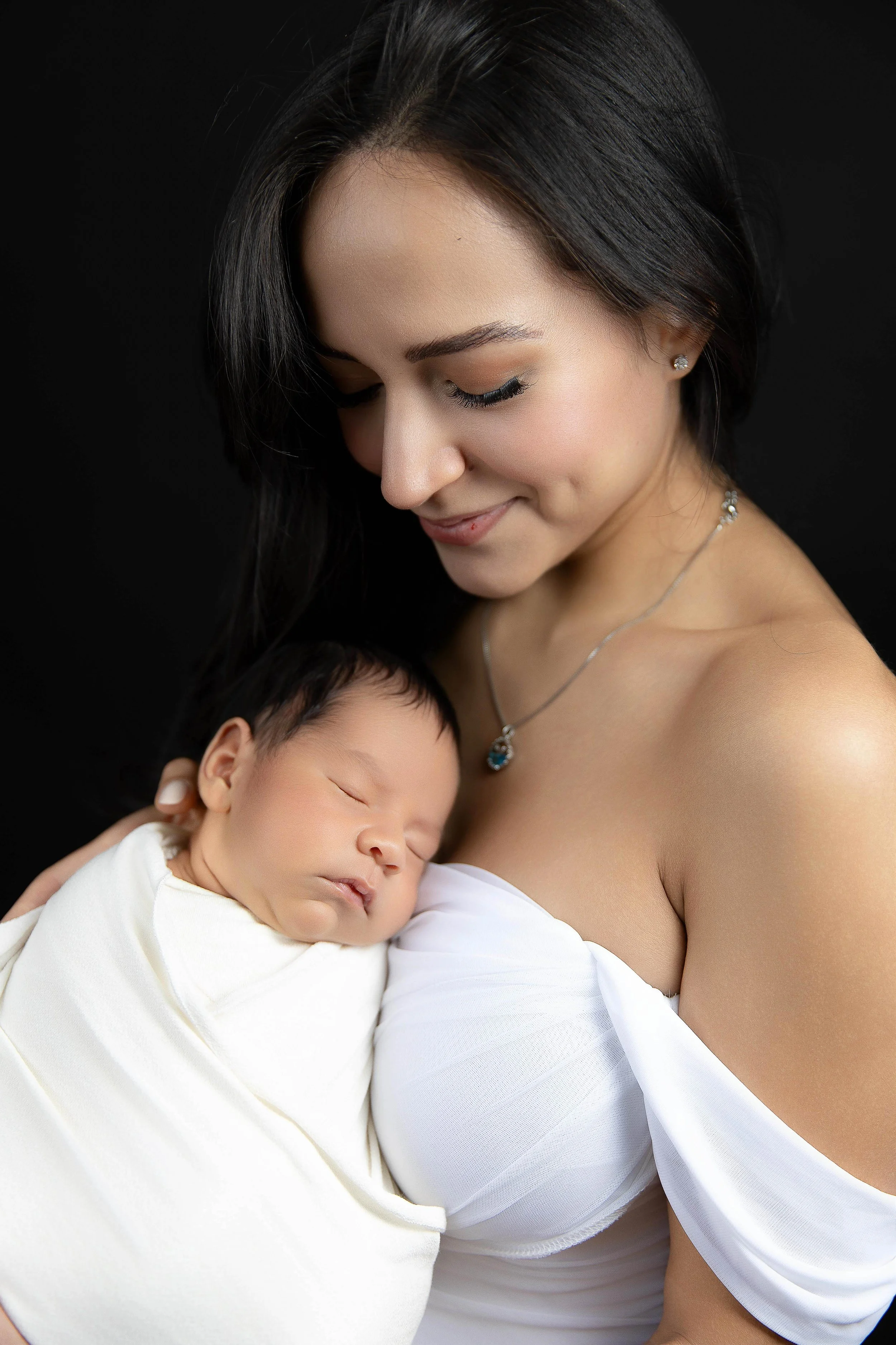 A photo of a mother and baby taken in palm desert newborn photography studio