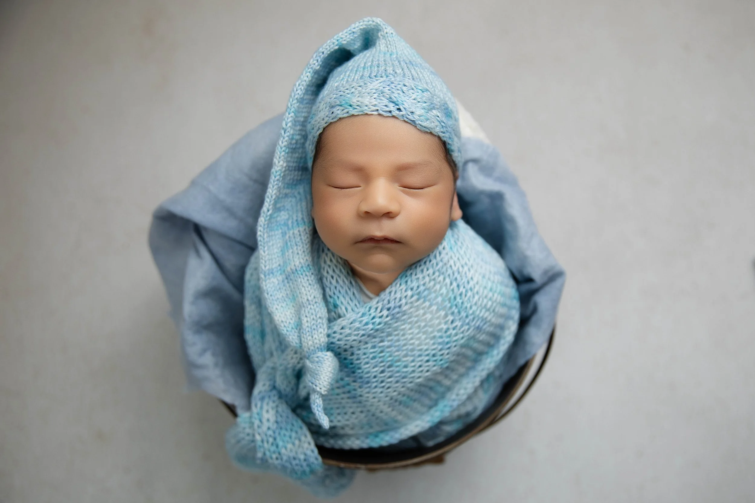 blue-baby-portrait.jpg Newborn baby peacefully wrapped in blue during a Palm Desert newborn photography session