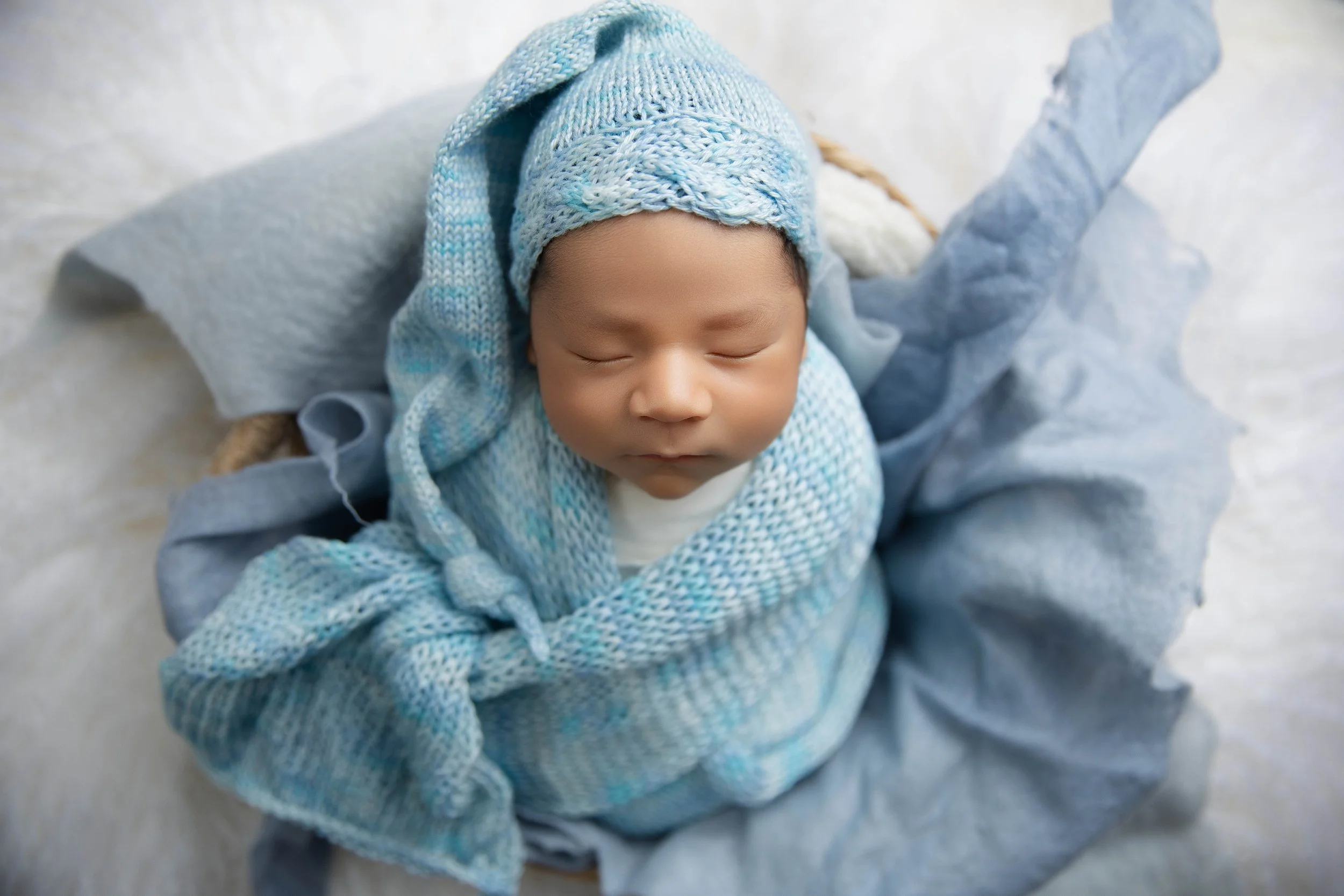 Newborn in blue wrap and layers in palm desert newborn photography studio
