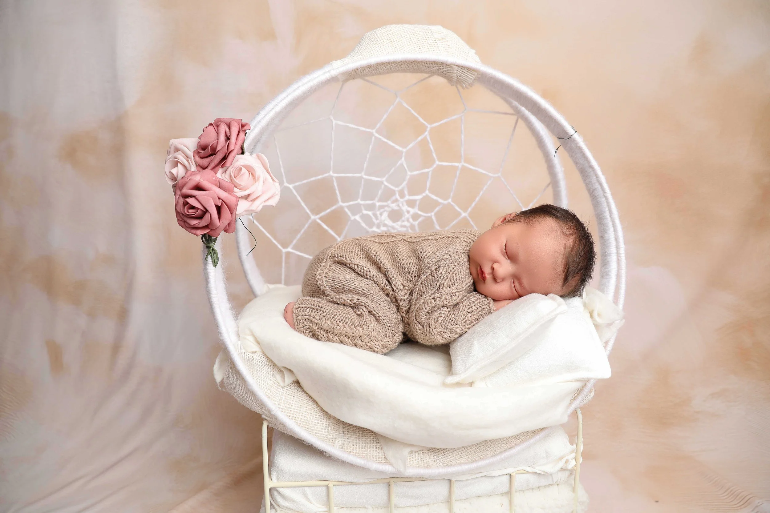 Baby safely placed on a support for photos