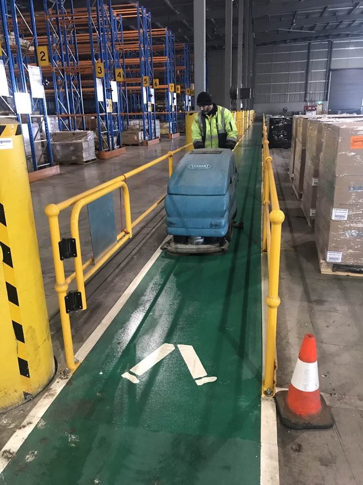 WAREHOUSE FLOOR CLEANING STARTS WITH SWEEPING THE FLOOR. Walkway focus ...
