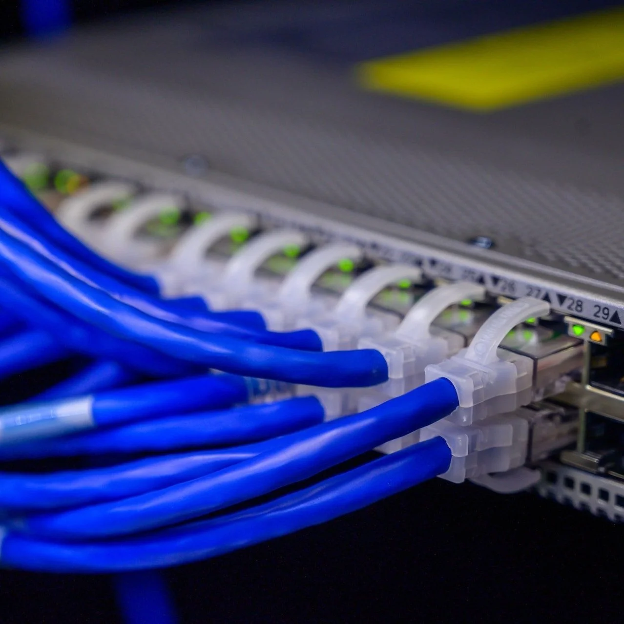 A close-up view of network cables plugged into a server or networking device.