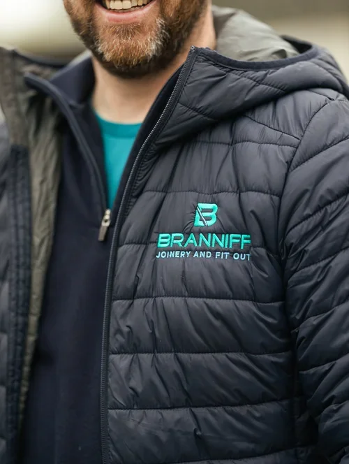 Corporate workwear branding with embroidered company logo for Brannif Joinery and Fit Out, designed by Brand Elevation.