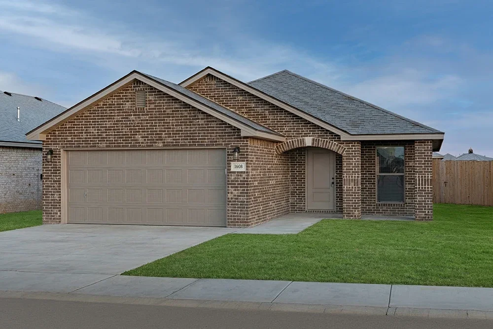 Single-story brick house with a two-car garage, front door under an arched brick entryway, and a well-maintained lawn.