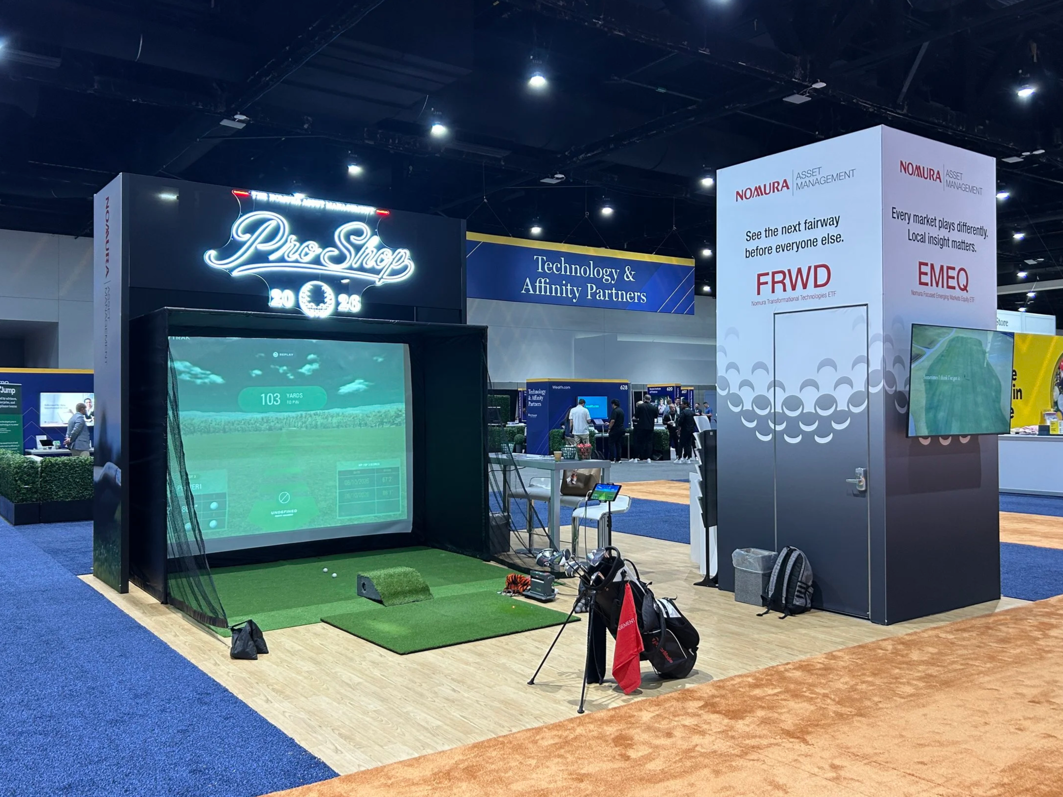 Nomura Asset Management booth featuring Straightshot golf simulator at San Diego Convention Center