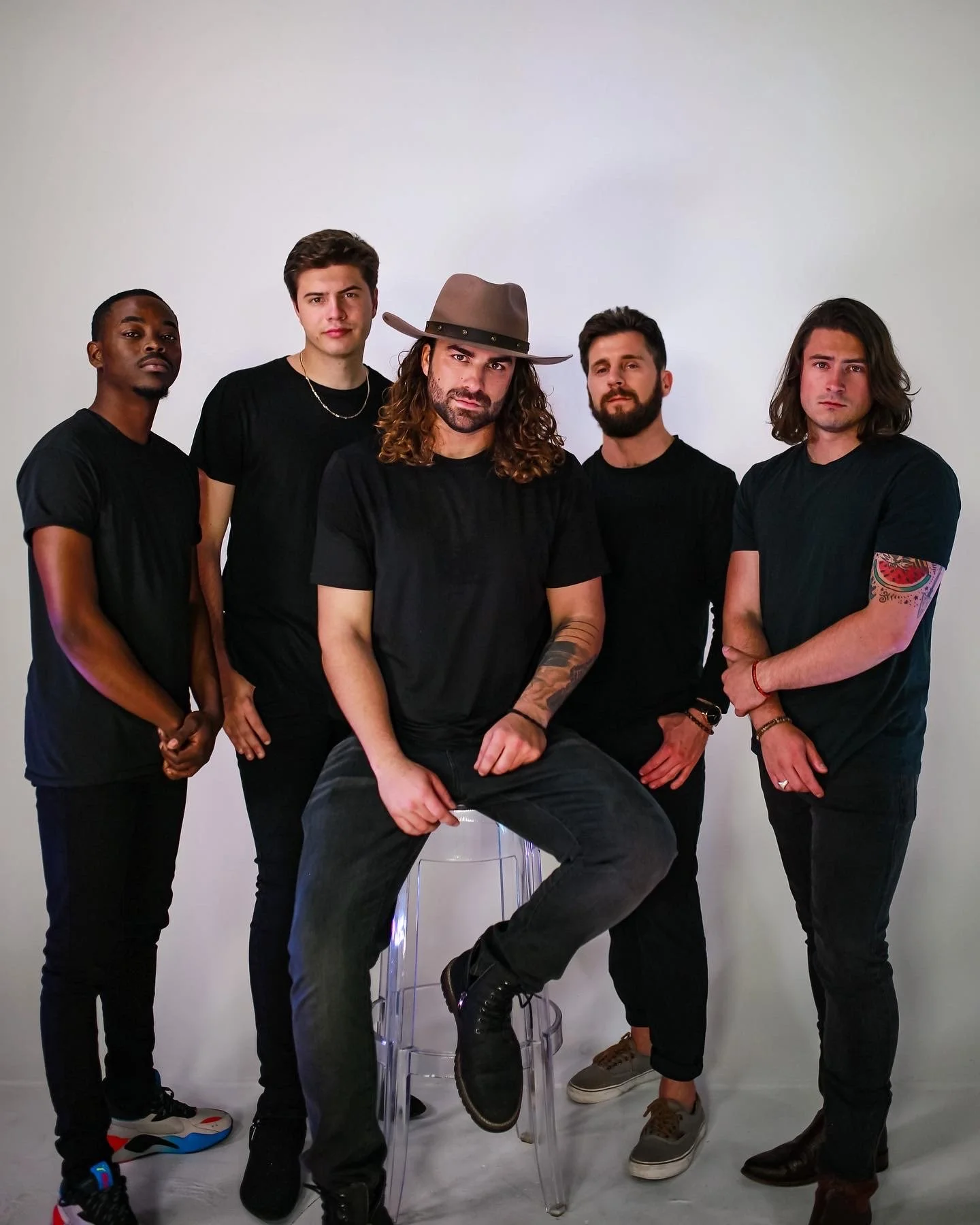 Keys and Company Events band members posing together in black outfits for a studio promo photo