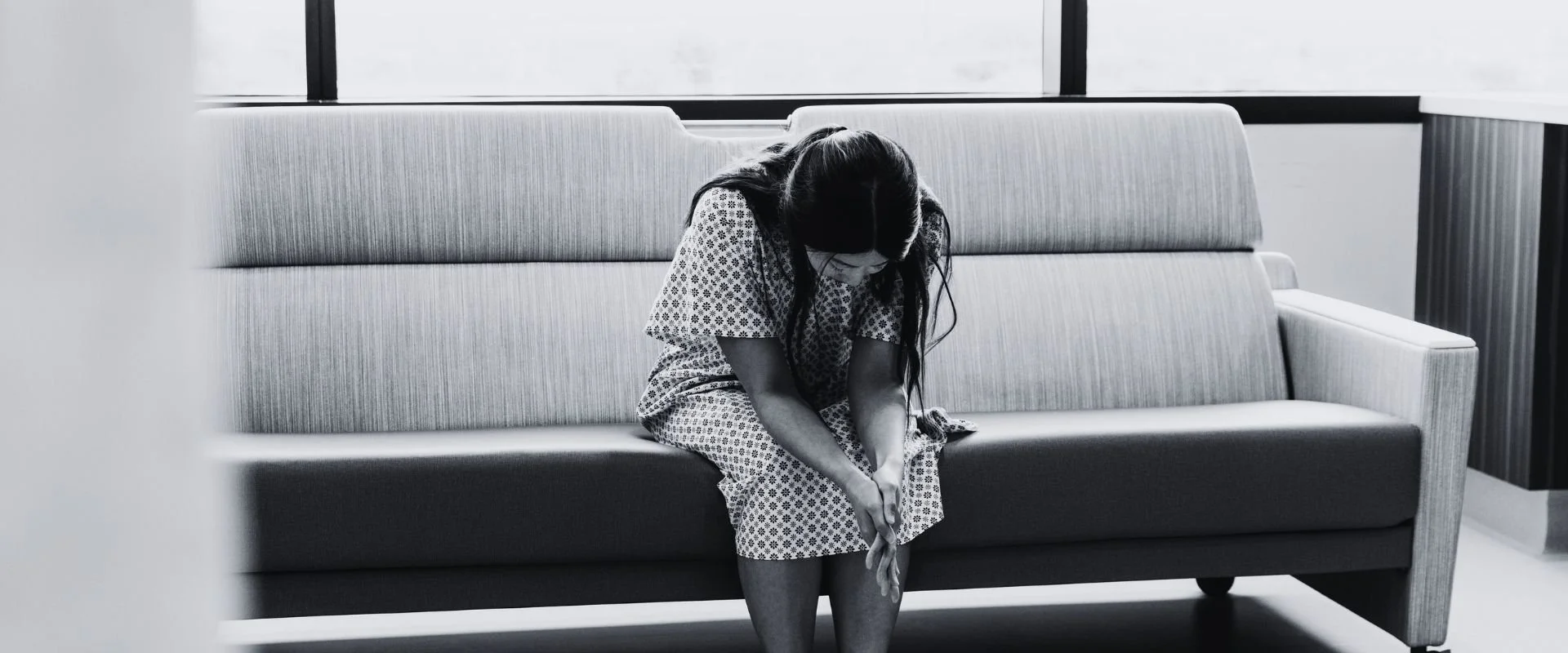 woman praying in hospital after child loss.