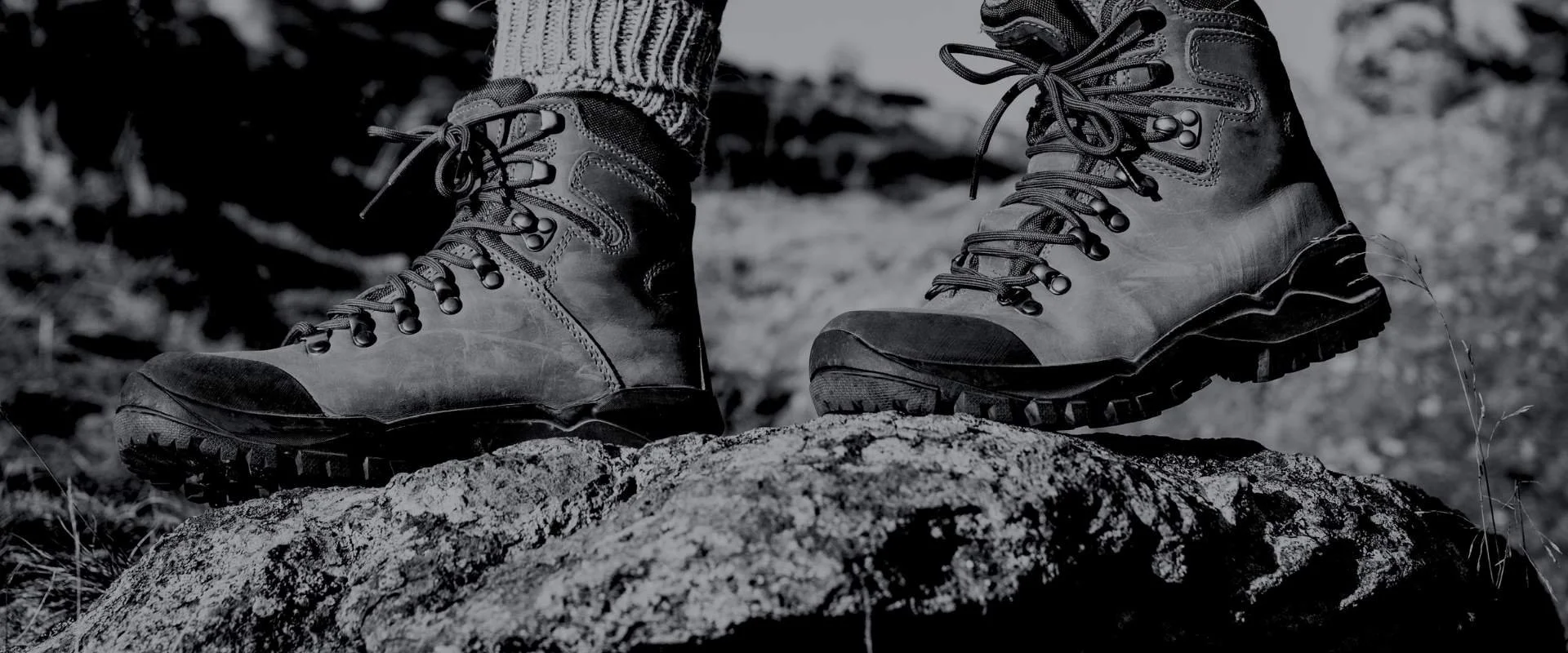 Hiker on a rock looking to God through tough times.