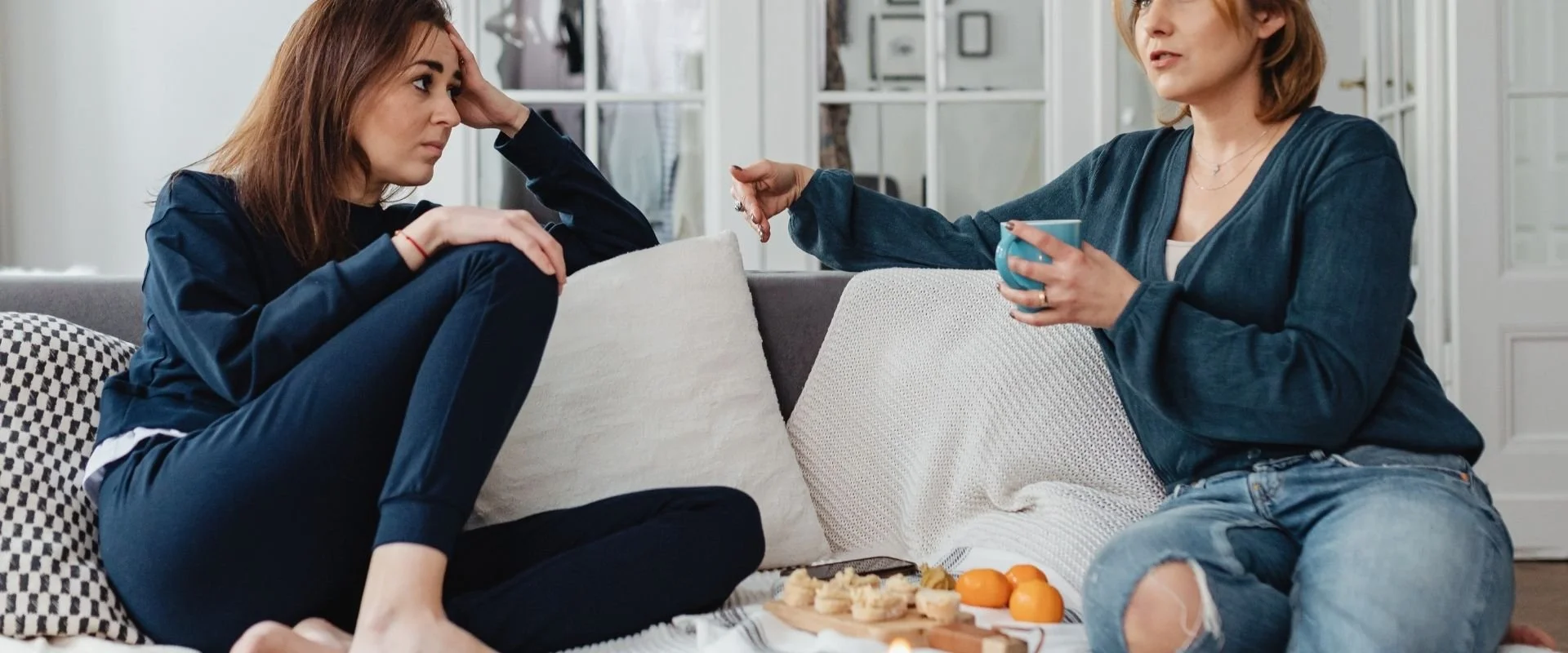 two women talking on a couch and sharing Jesus.