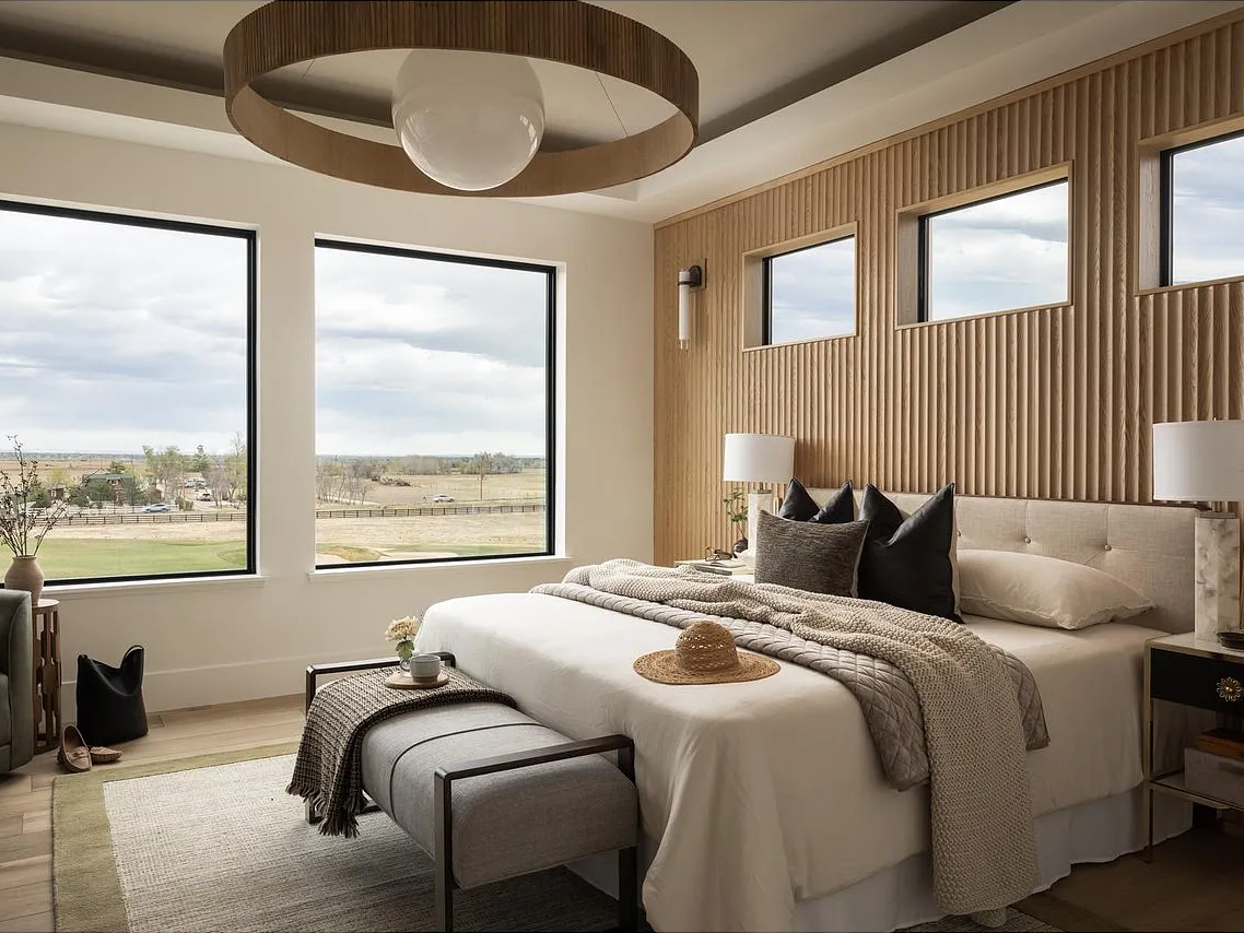 The Arena ring-and-globe chandelier over the fluted oak wall.