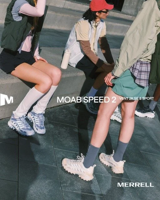 Three people in sportwear sitting and standing outdoors, focusing on their legs and footwear, with urban surroundings