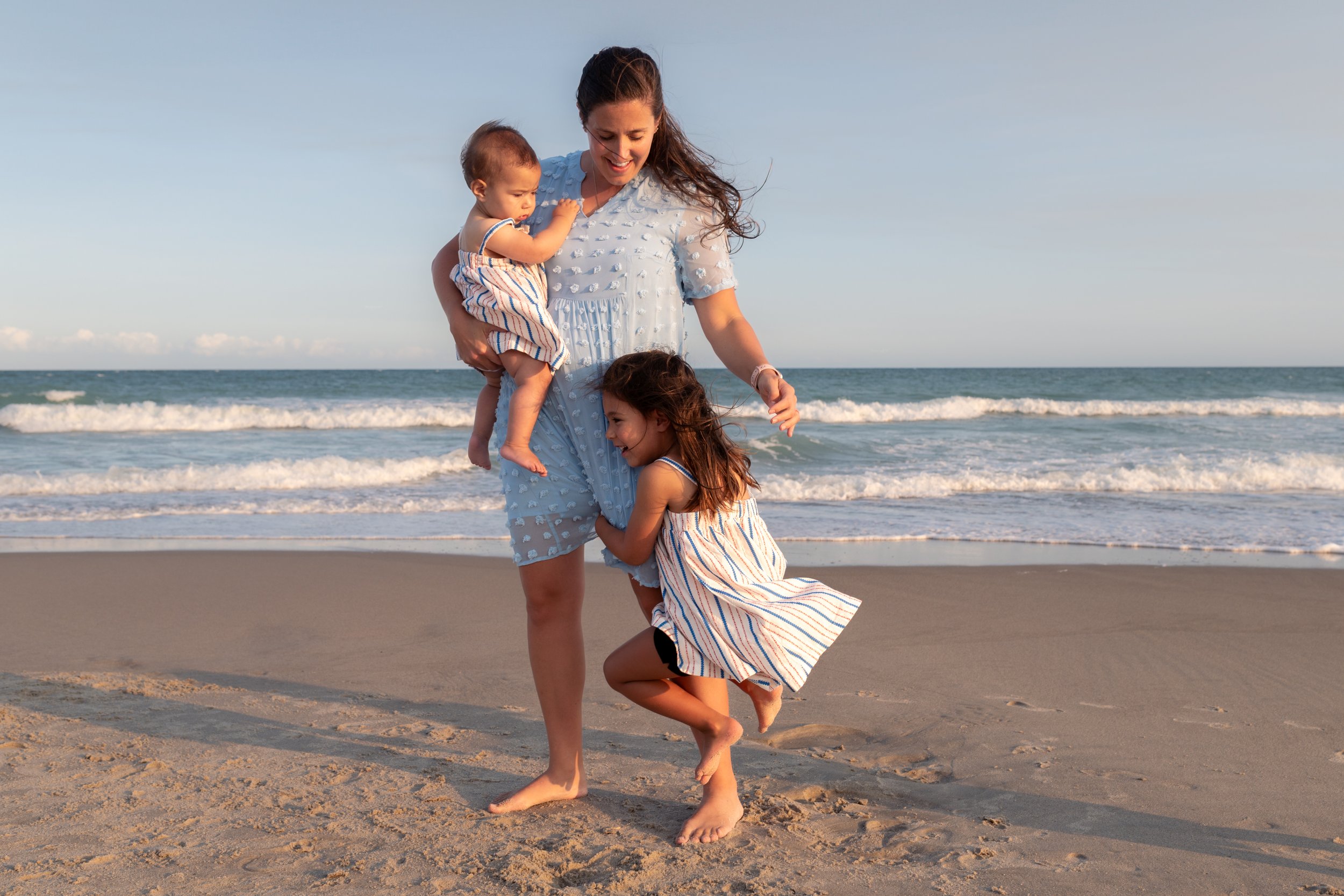 Family photography by Briana Woods: Candid-style family photography on the beach.