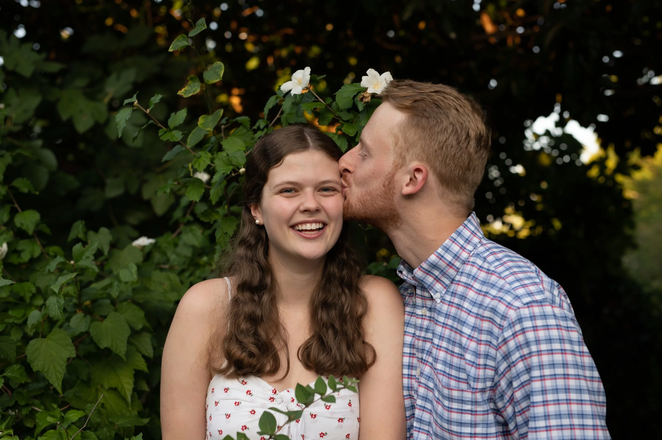 Engagement photography by Briana Woods: Couple shares a forehead kiss.