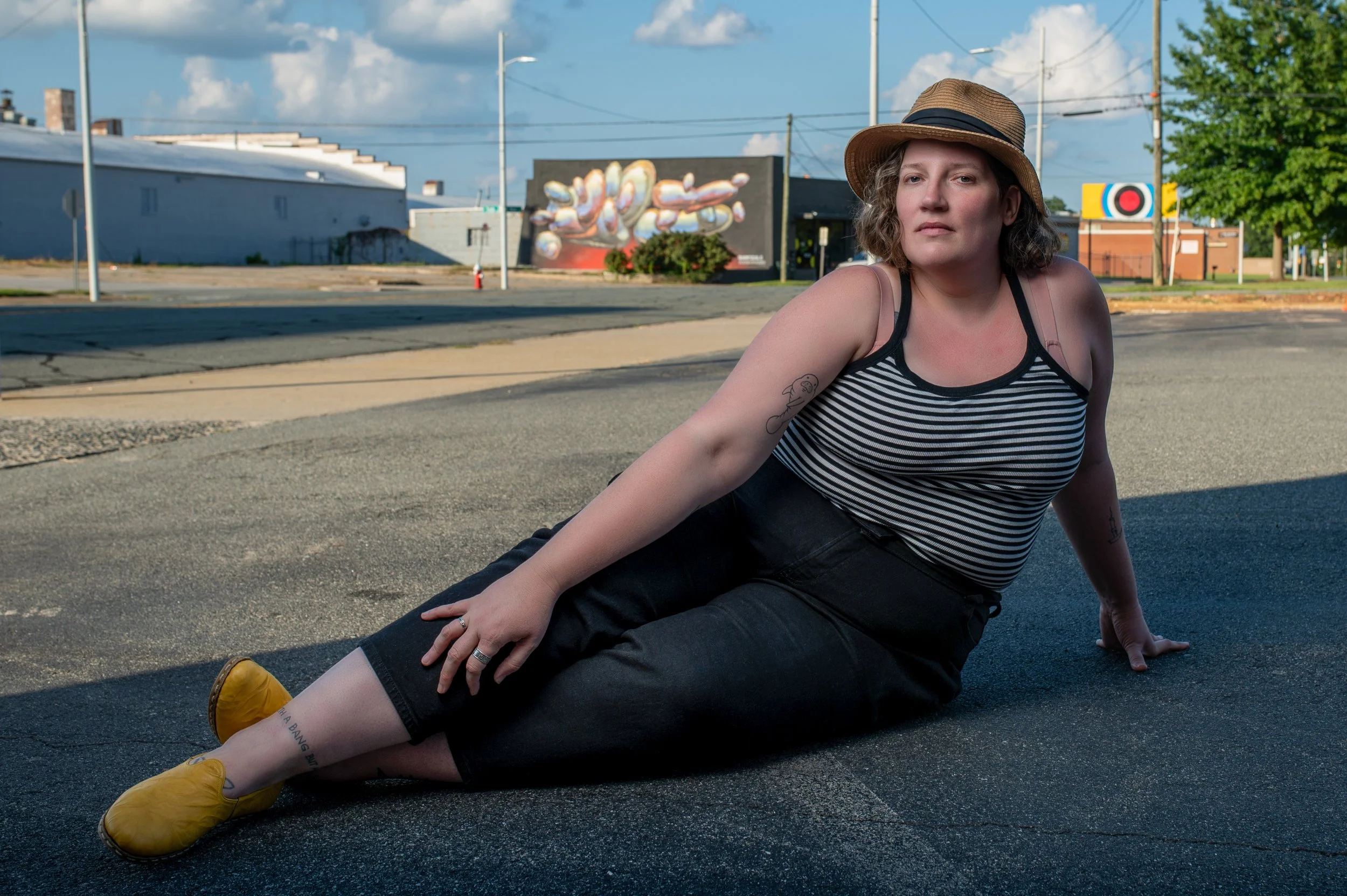 Full body, reclining portrait. Editorial photoshoot in warehouse district. Burlington Raleigh Durham.