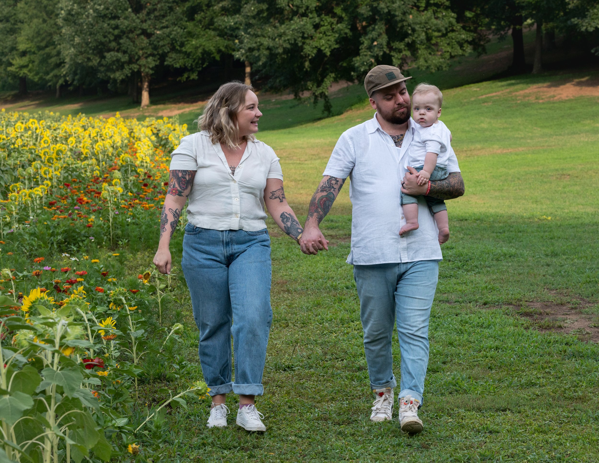 Family photography by Briana Woods: Family strolling at the Dix Park sunflower field in Raleigh.