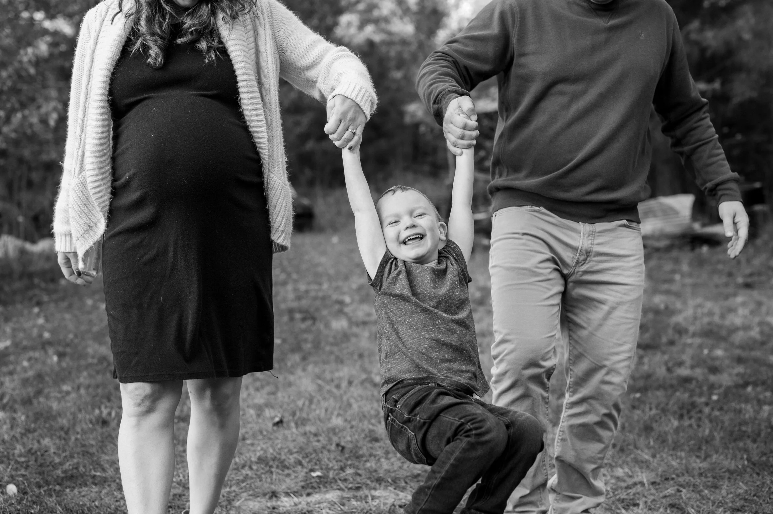 Maternity photography by Briana Woods: Fall family session - couple plays with young son.