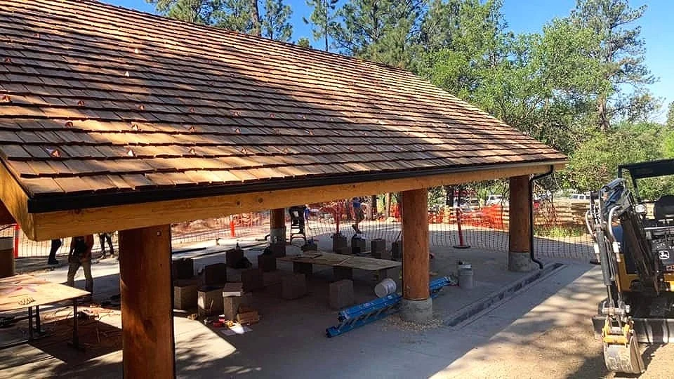 Gutters installed on a large wooden building by Vazquez Garage Doors and Gutters
