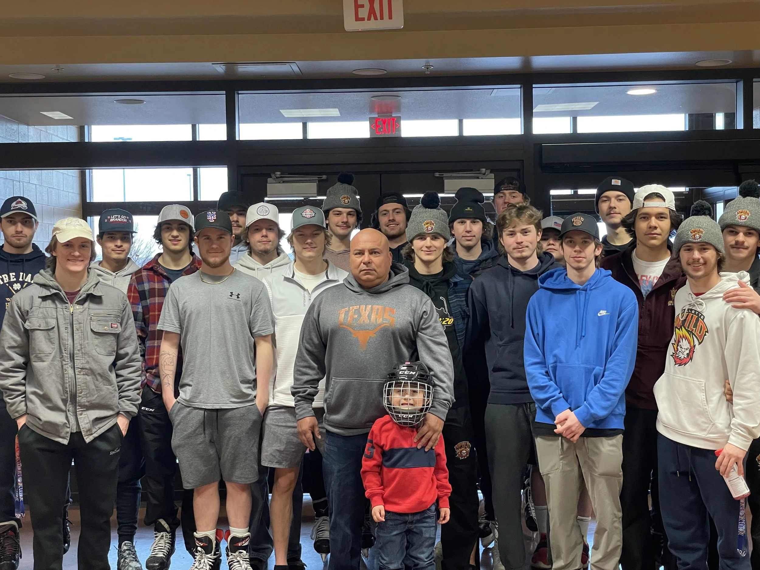 Group photo of Gillette Wild Jr. Hockey players with the owner of Vazquez Garage Doors and Gutters