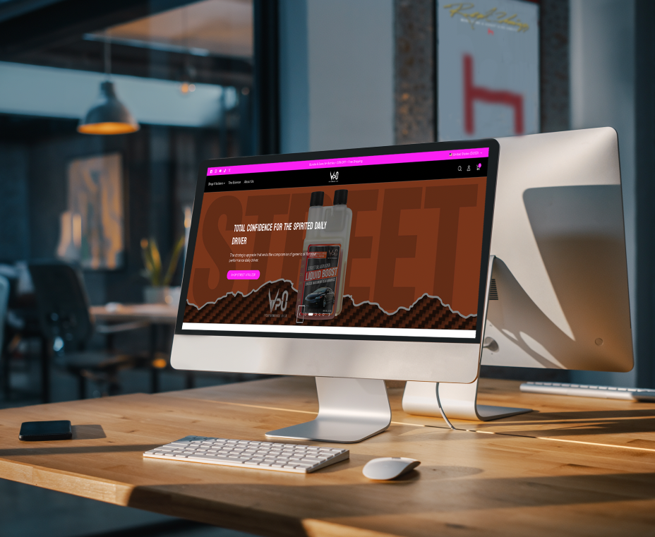 Desktop computer displaying a webpage for a liquid boost product, on a wooden desk in a modern office.