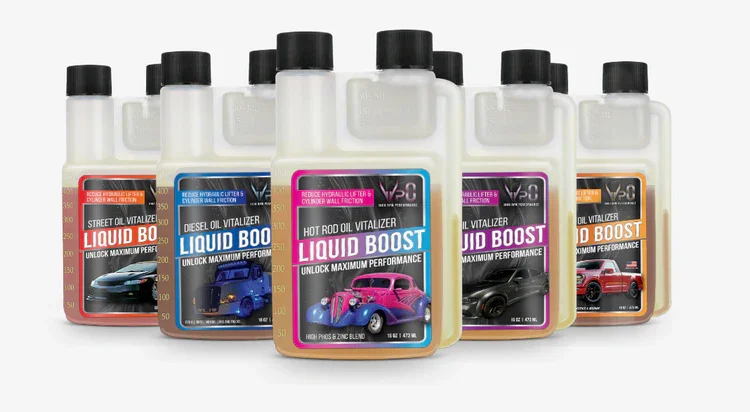 Five bottles of automotive fuel additives labeled 'Liquid Boost', each with different colors and vehicle images on the labels, arranged in a row.