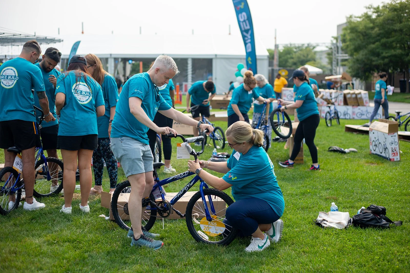 Employees working together to build bicycles during a large-group Bike Build & Give event