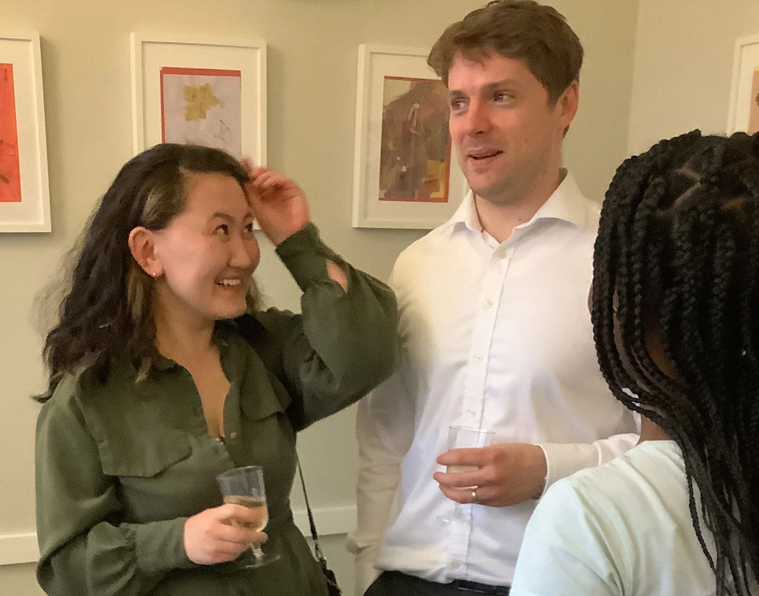 Parents talking and enjoying drinks during a nursery community evening.