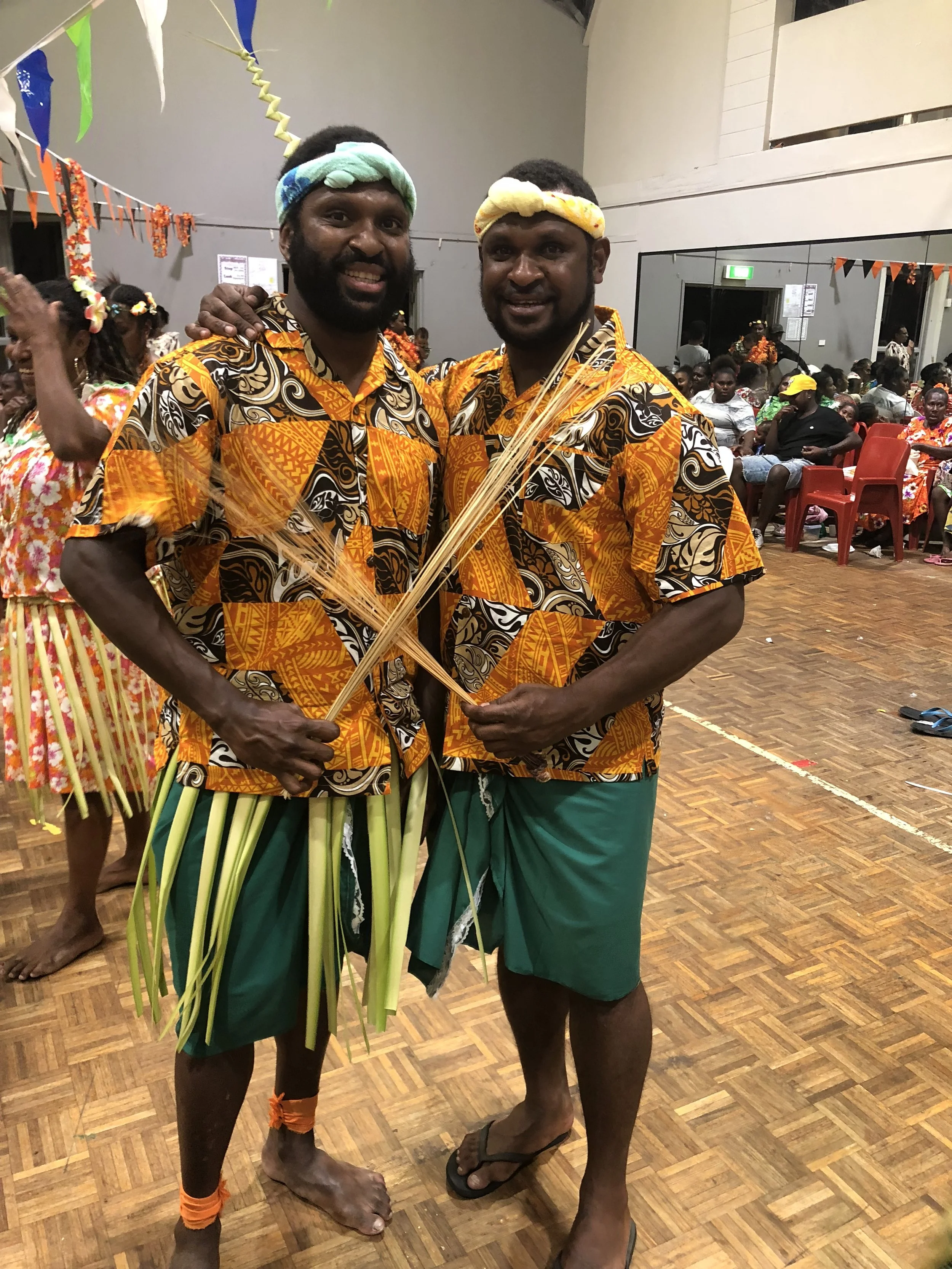 An image of two brothers from Boigu Island performing as part of a Traditional Shaving party