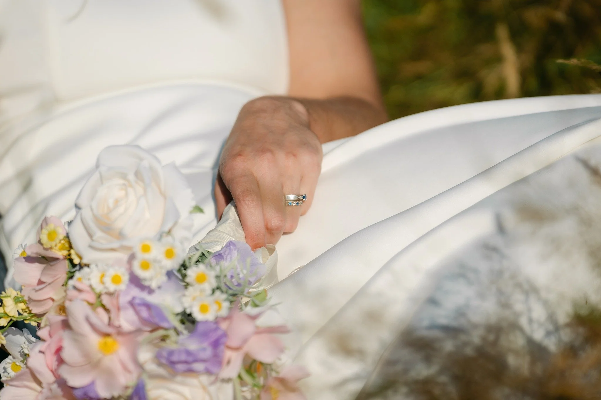 A quiet little photograph of so many meaningful things.

The ring, the bouquet, the dress and a hand being held just out of frame. In the middle of such a big day, it is often the smallest moments captured that bring everything flooding back.

Captur