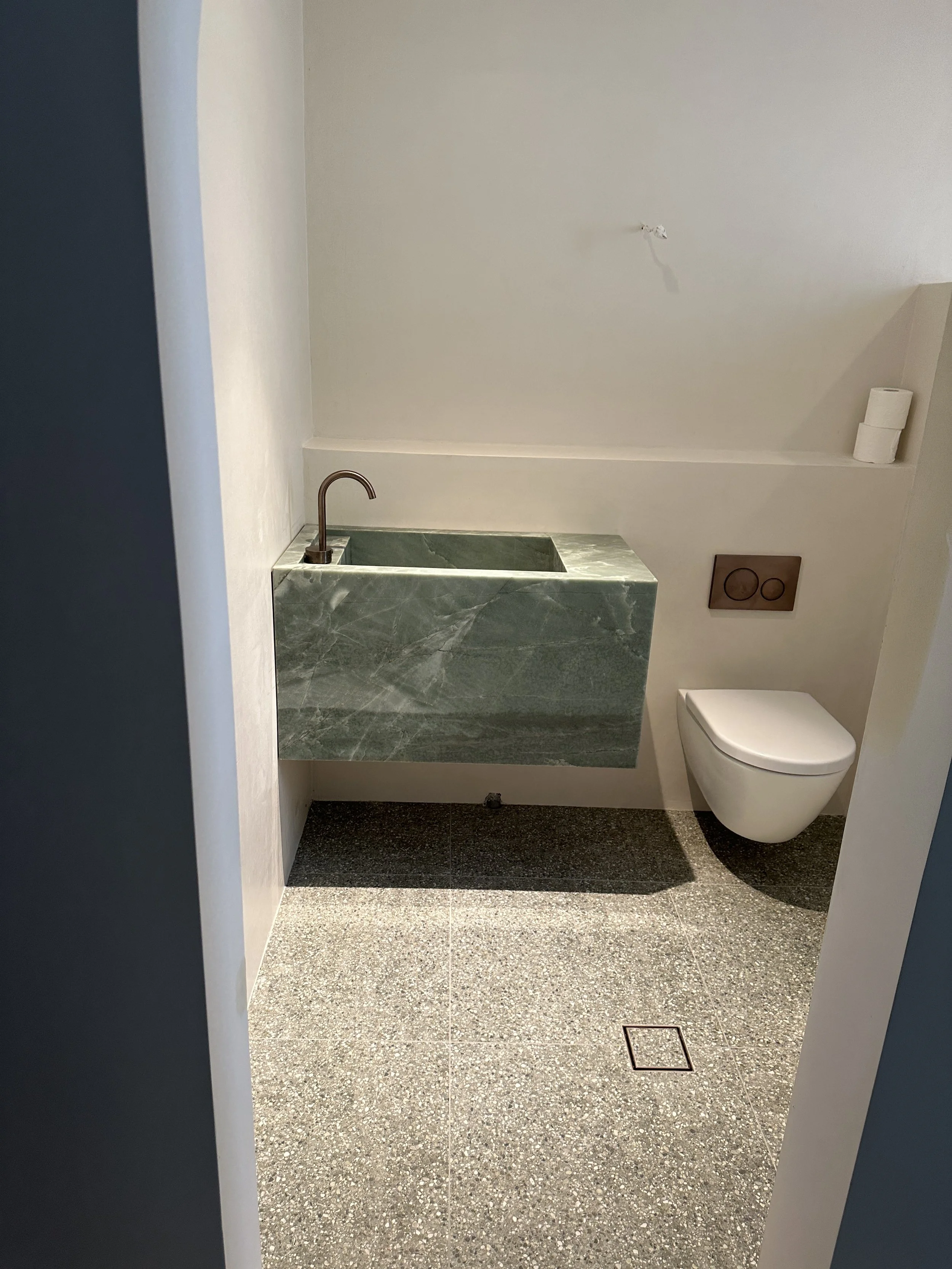 Marble Basin And Wall Hung Toilet With In-Wall Cistern At A Noosa Renovation For Iezzi Built