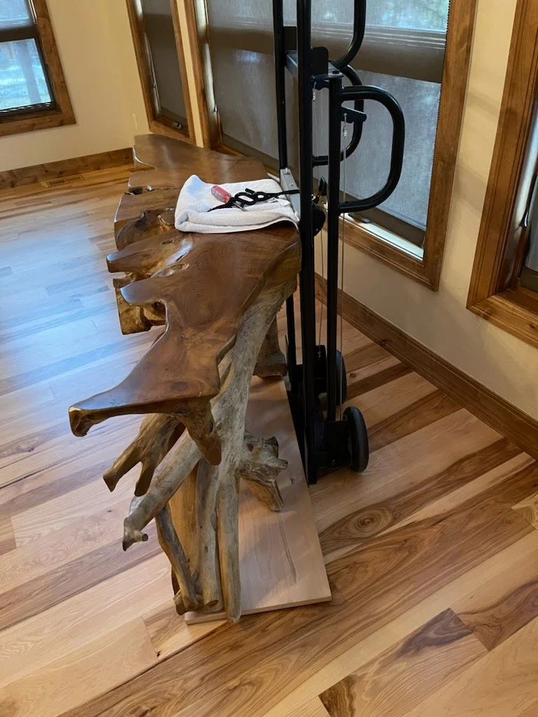 360 precision hand truck with pivoted wheels holding an oddly shaped live edge wood table