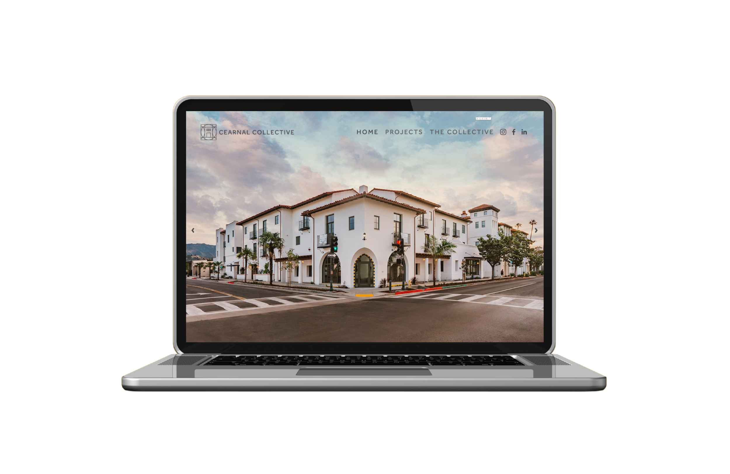 Laptop displaying a website with a photo of a white multi-story building with arches, palm trees, and a street intersection in the foreground.